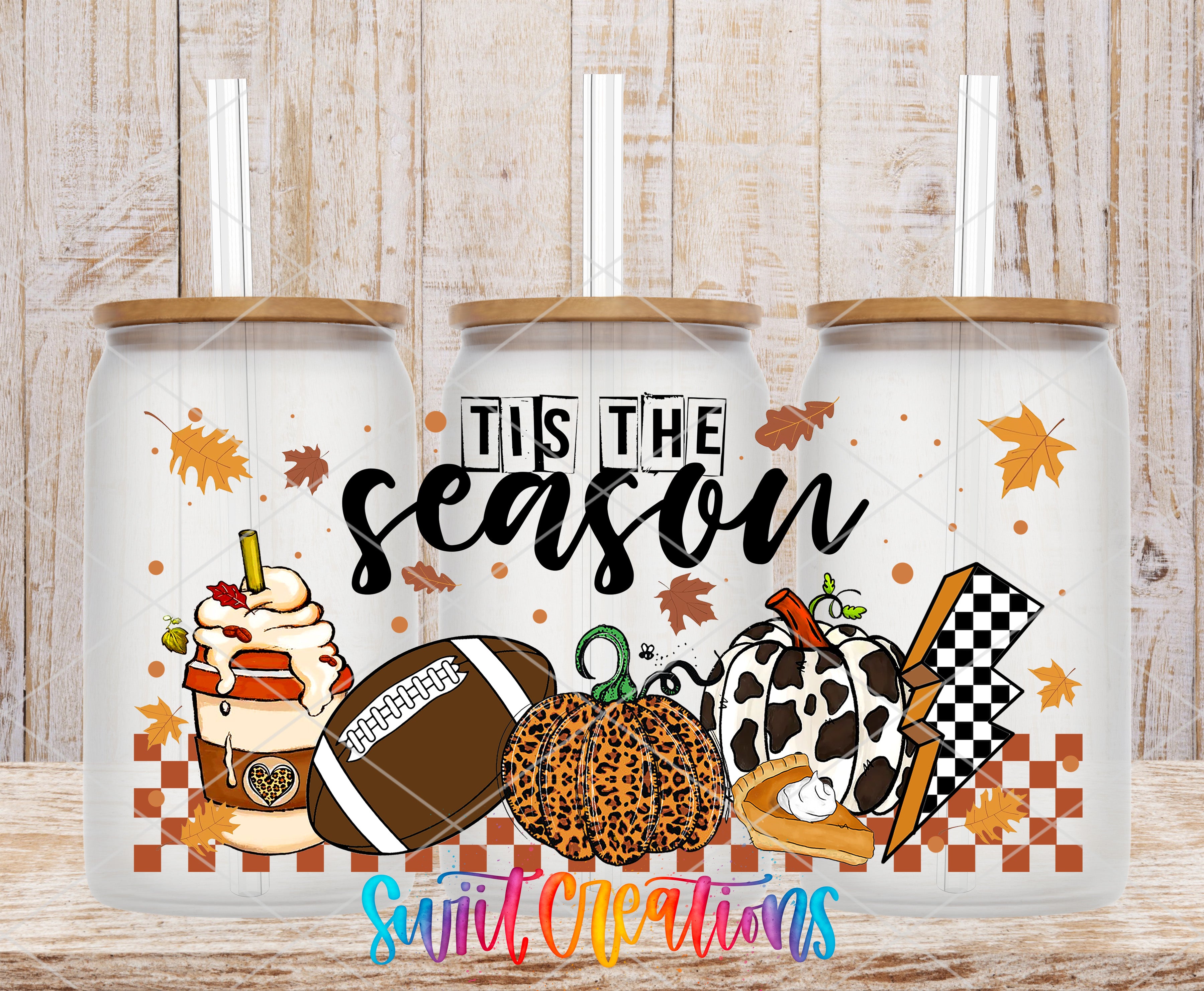 A collection of three glass tumblers with a seasonal design, including a football, pumpkin, and checkered flag motif, along with the text "TIS THE SEASON" and "Sweet Creations" printed on them.