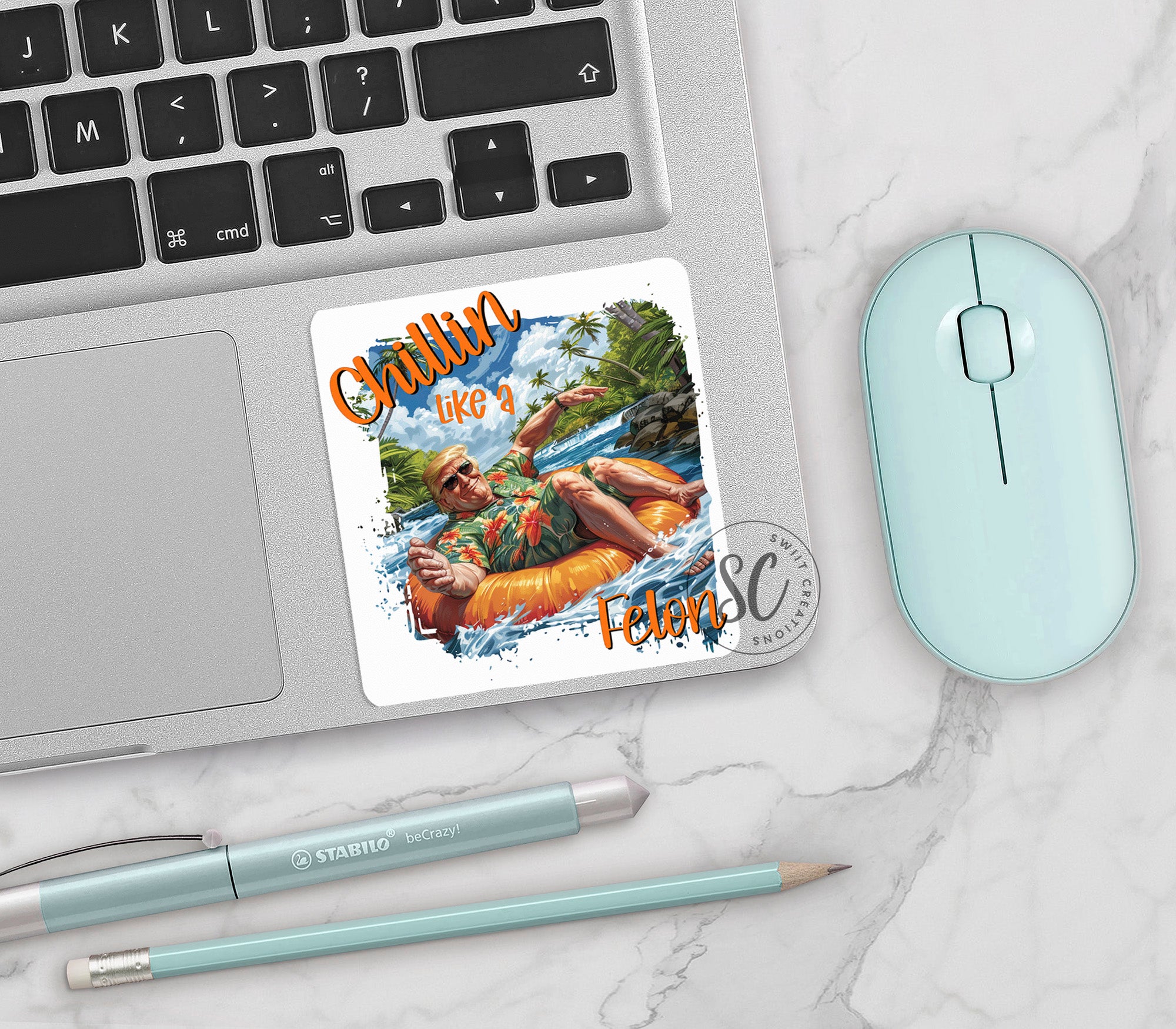 a mouse, keyboard, and sticker on a laptop