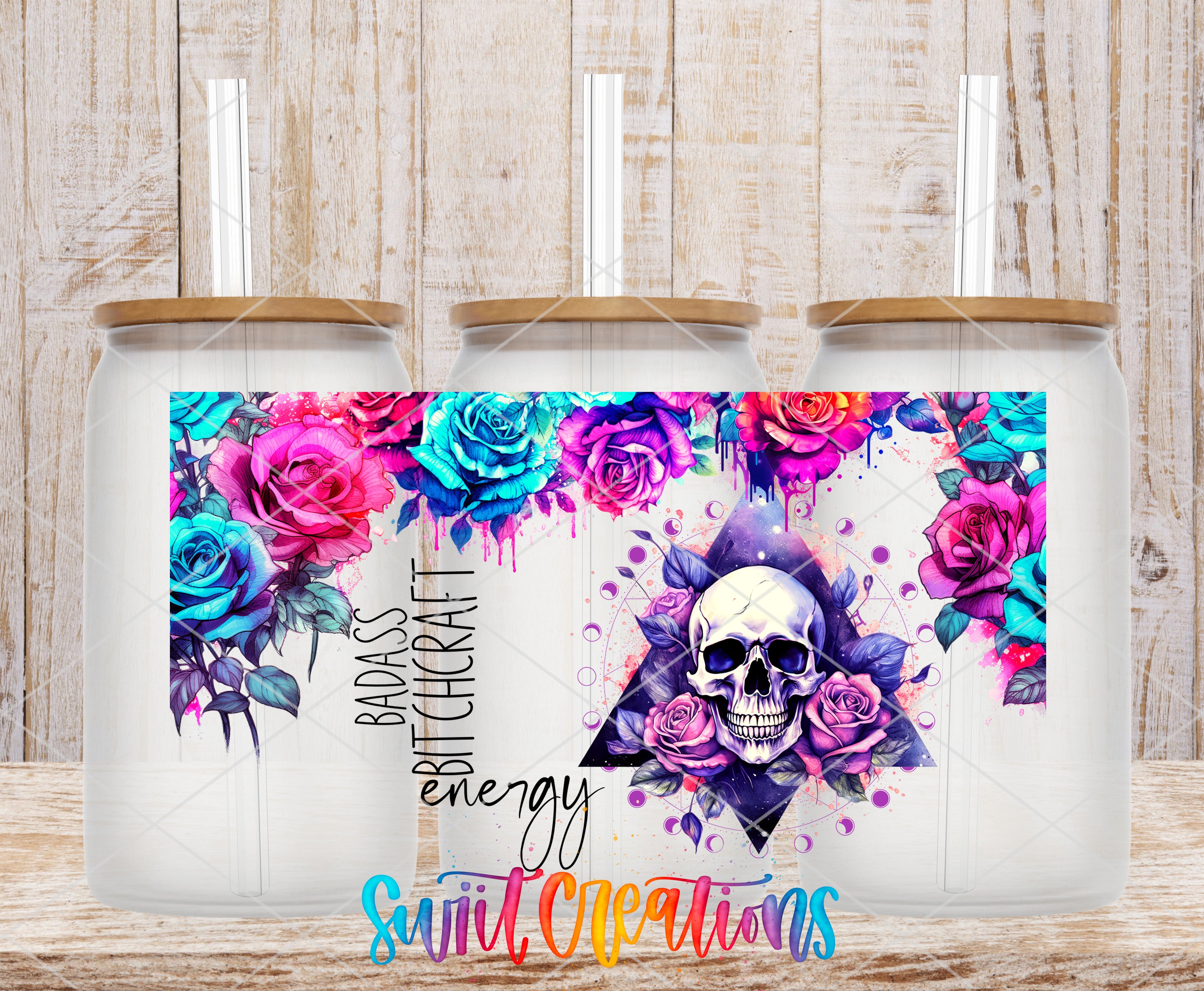 A colorful tumbler with a skull design and floral elements, along with the text "Badass Bitch energy" and "Sweet Creations" printed on it.