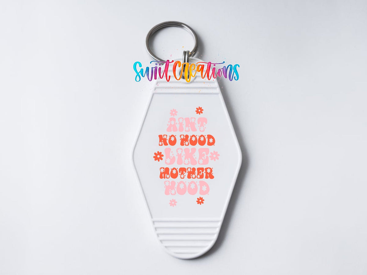 Close-up of the Ain't No Hood Like Motherhood UV DTF transfer on a white motel keychain
