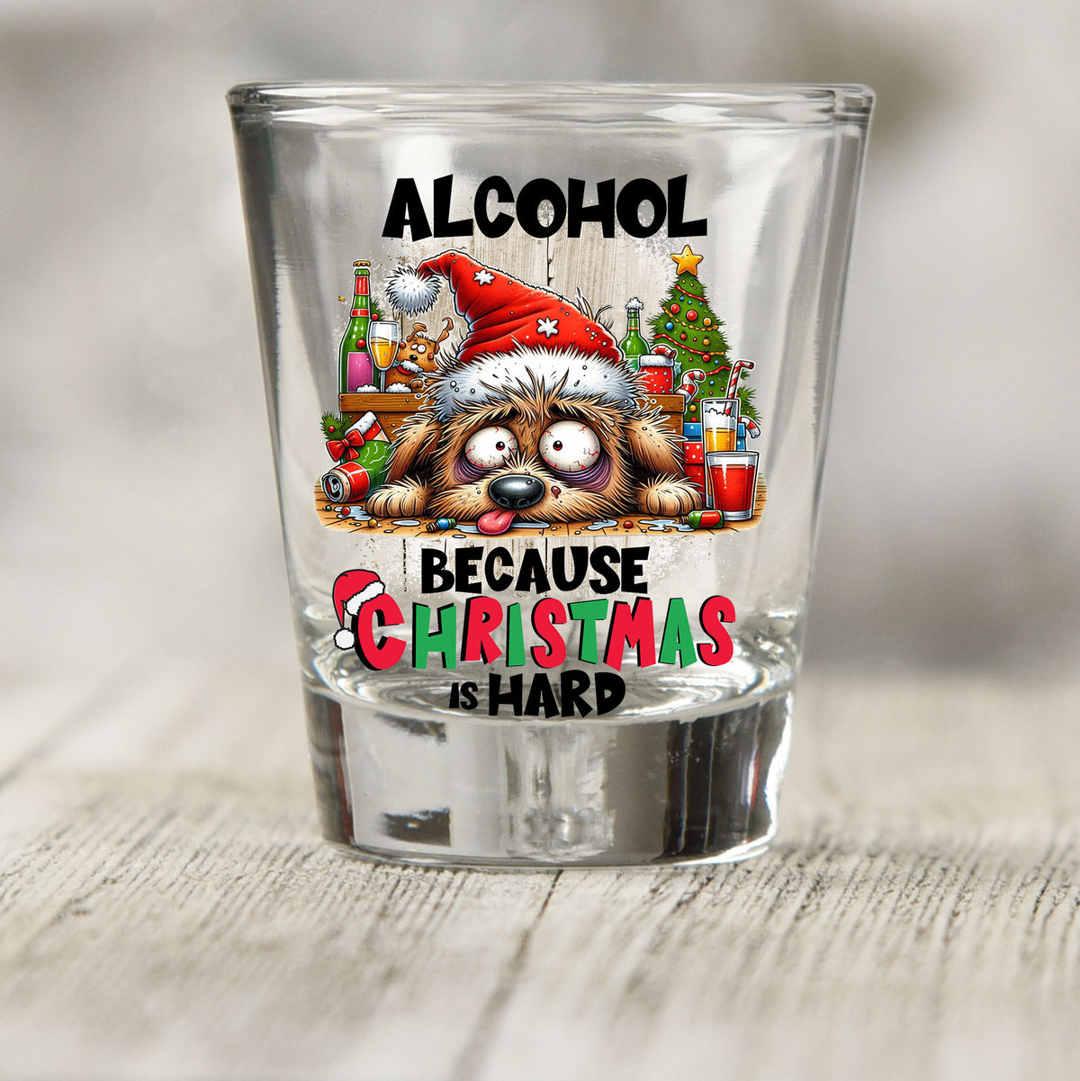 Alcohol Because Christmas is Hard shot glass UV DTF transfer with tired dog in a Santa hat with bottles and a tree on a clear shot glass