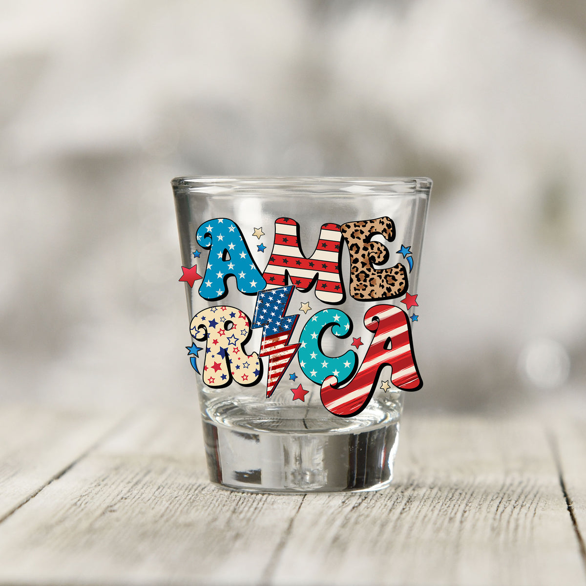Close-up of the America UV DTF transfer on a clear shot glass