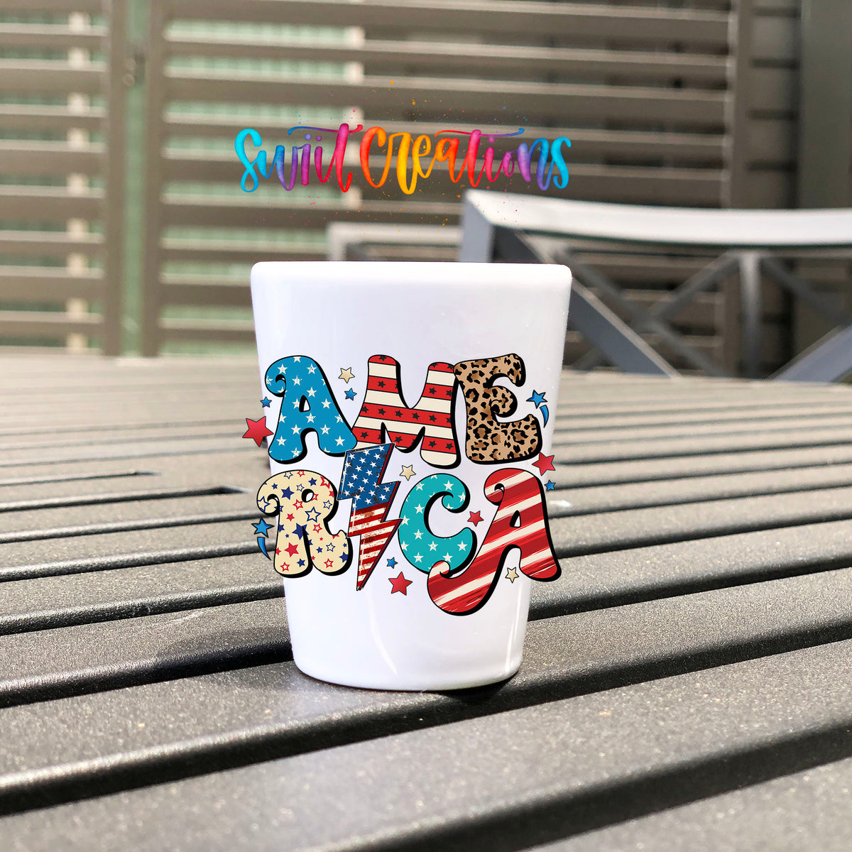 America UV DTF transfer on a white shot glass on an outdoor patio table