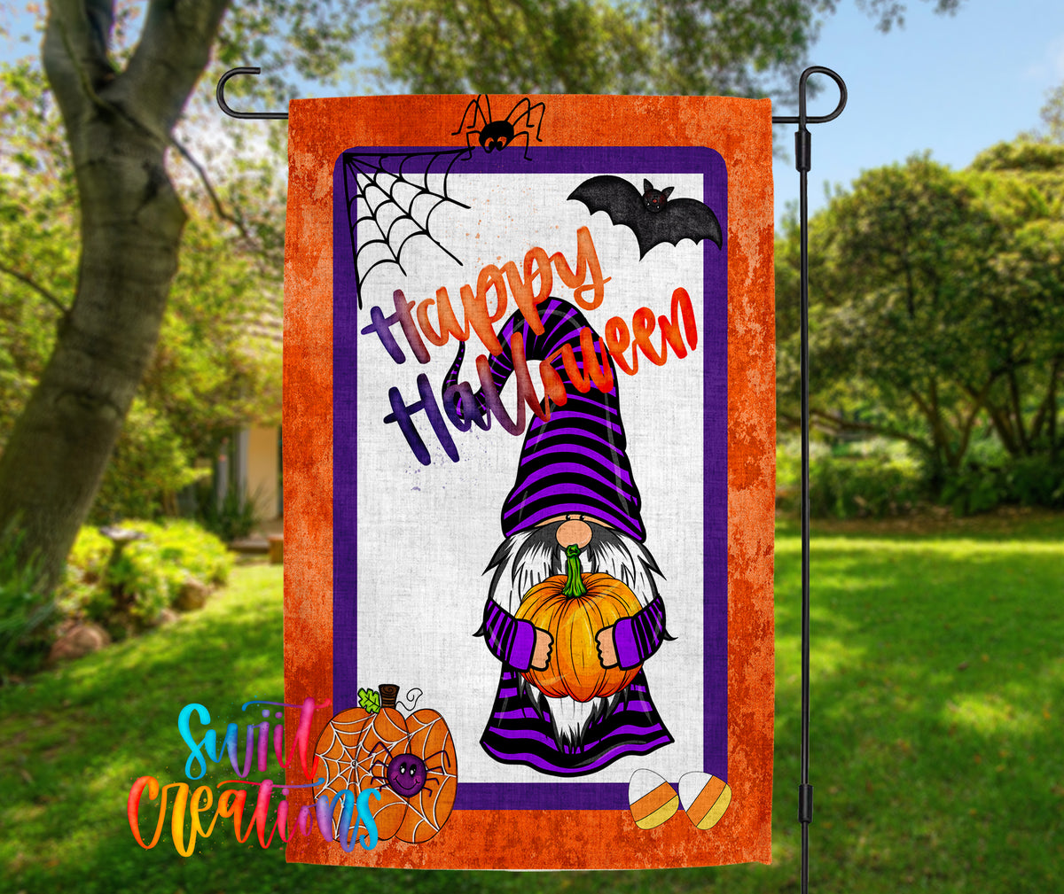 a Halloween-themed garden flag with a gnome holding a pumpkin and a spider web.