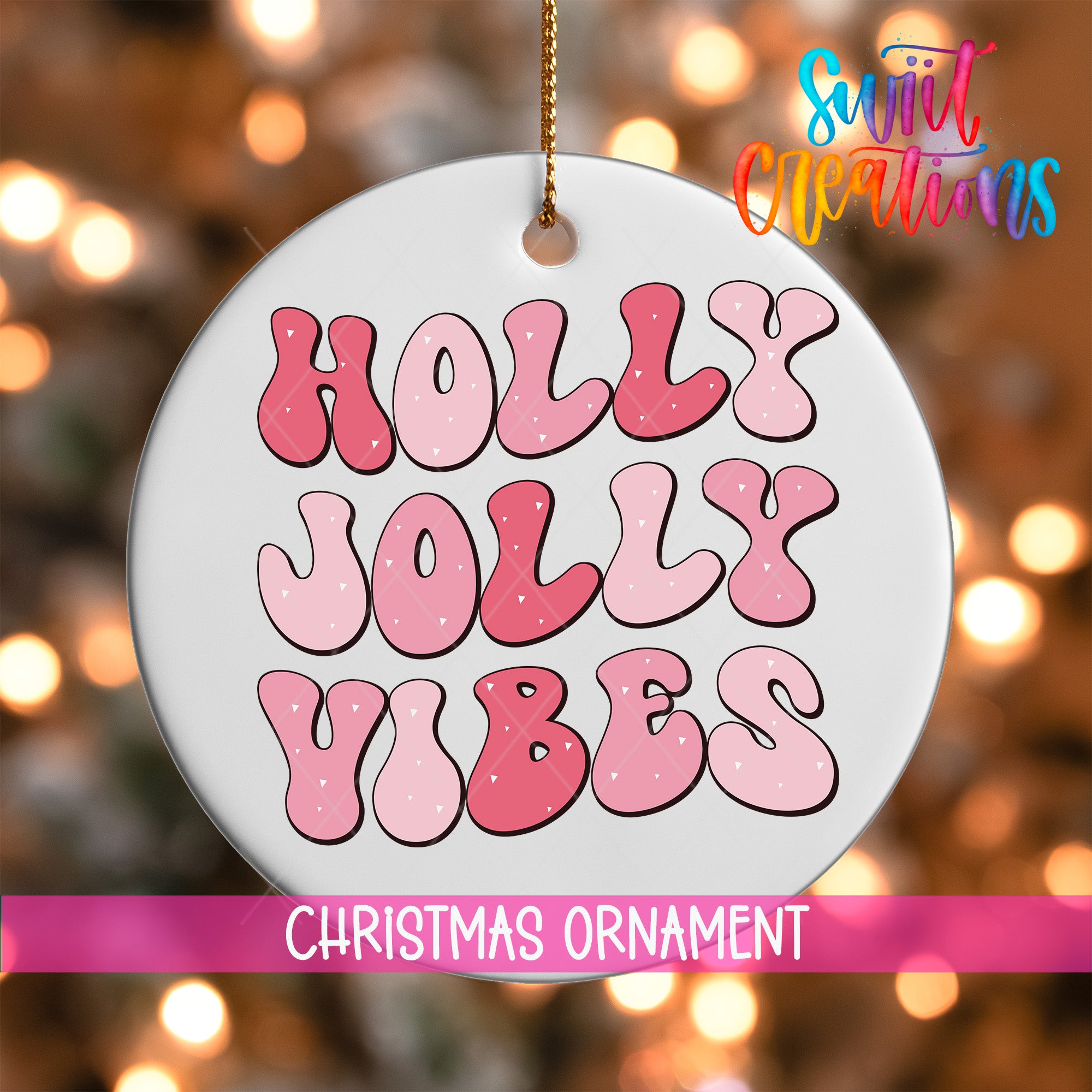 A white Christmas ornament with the text "Holly Jolly Vibes" in pink and red letters.