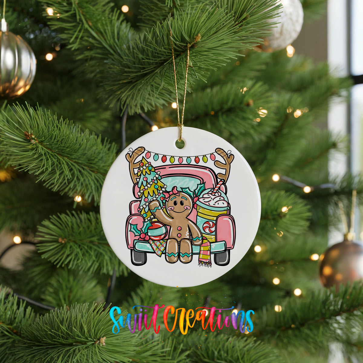 A white ceramic ornament hanging on a Christmas tree, featuring a gingerbread man sitting in a pink truck with a Christmas tree and ornaments.