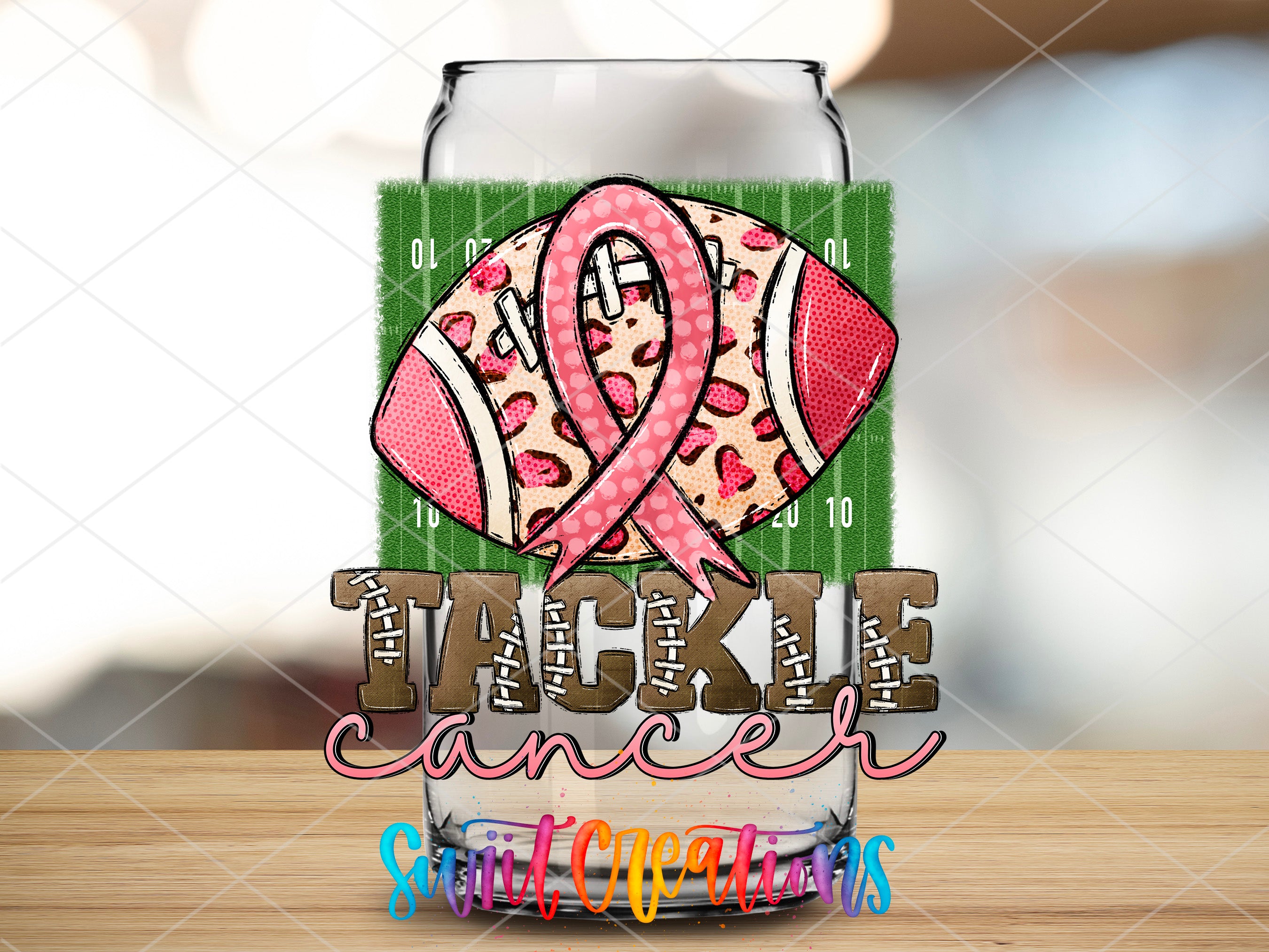 a glass with a pink ribbon on it