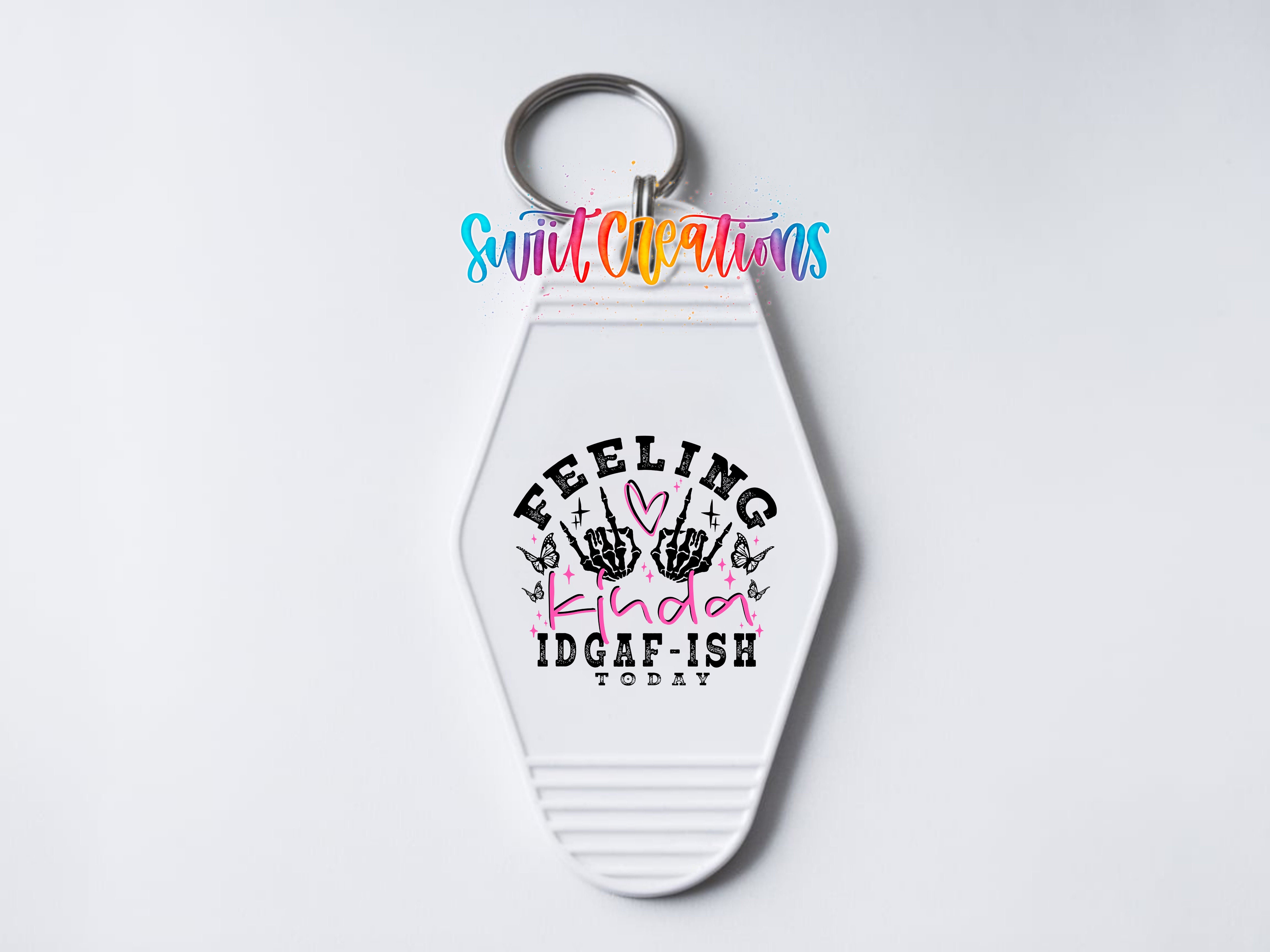 A keychain with a white hexagonal shape and a colorful design featuring text and graphics.
