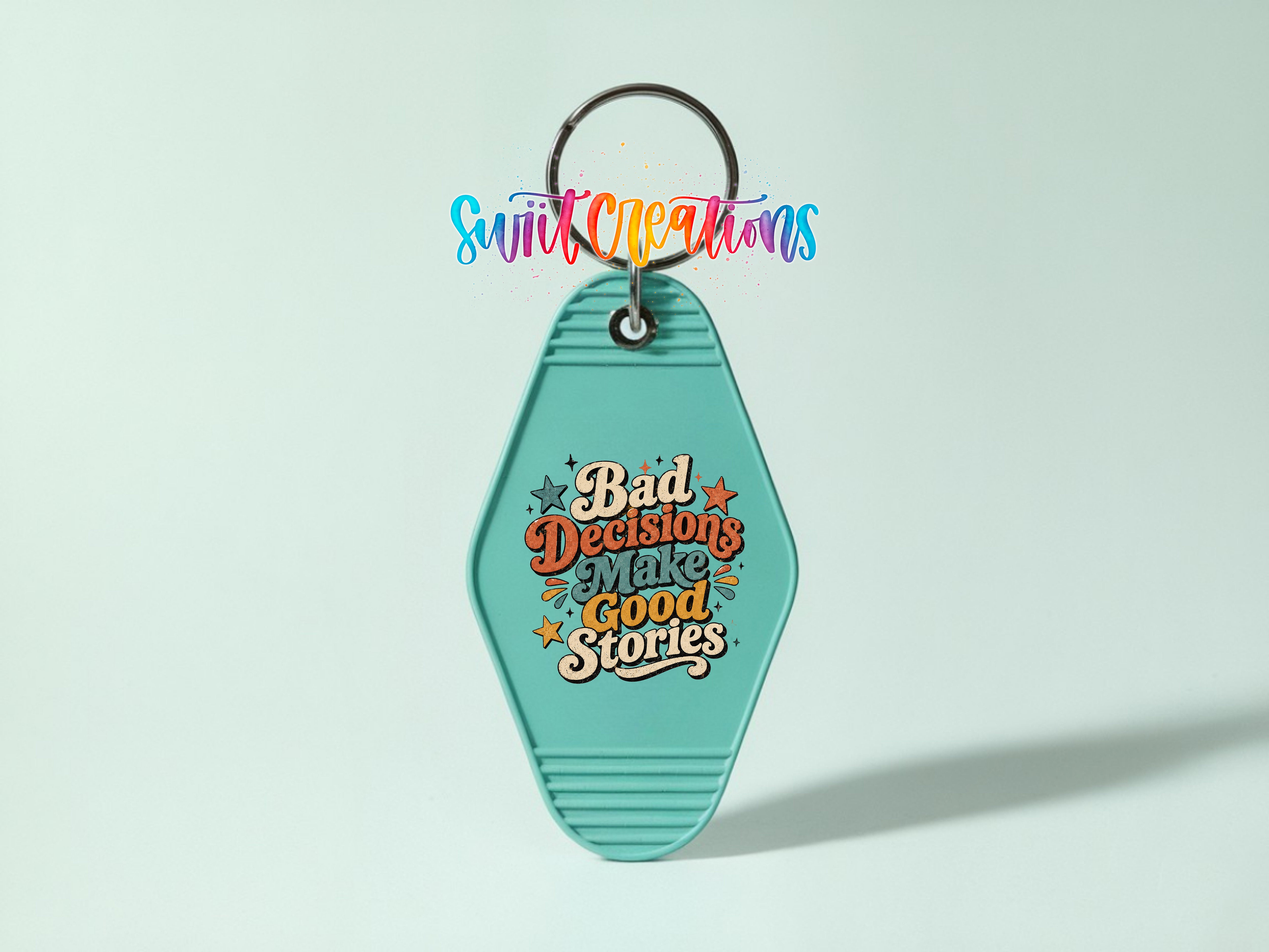 A turquoise keychain with a colorful graphic and text on it.