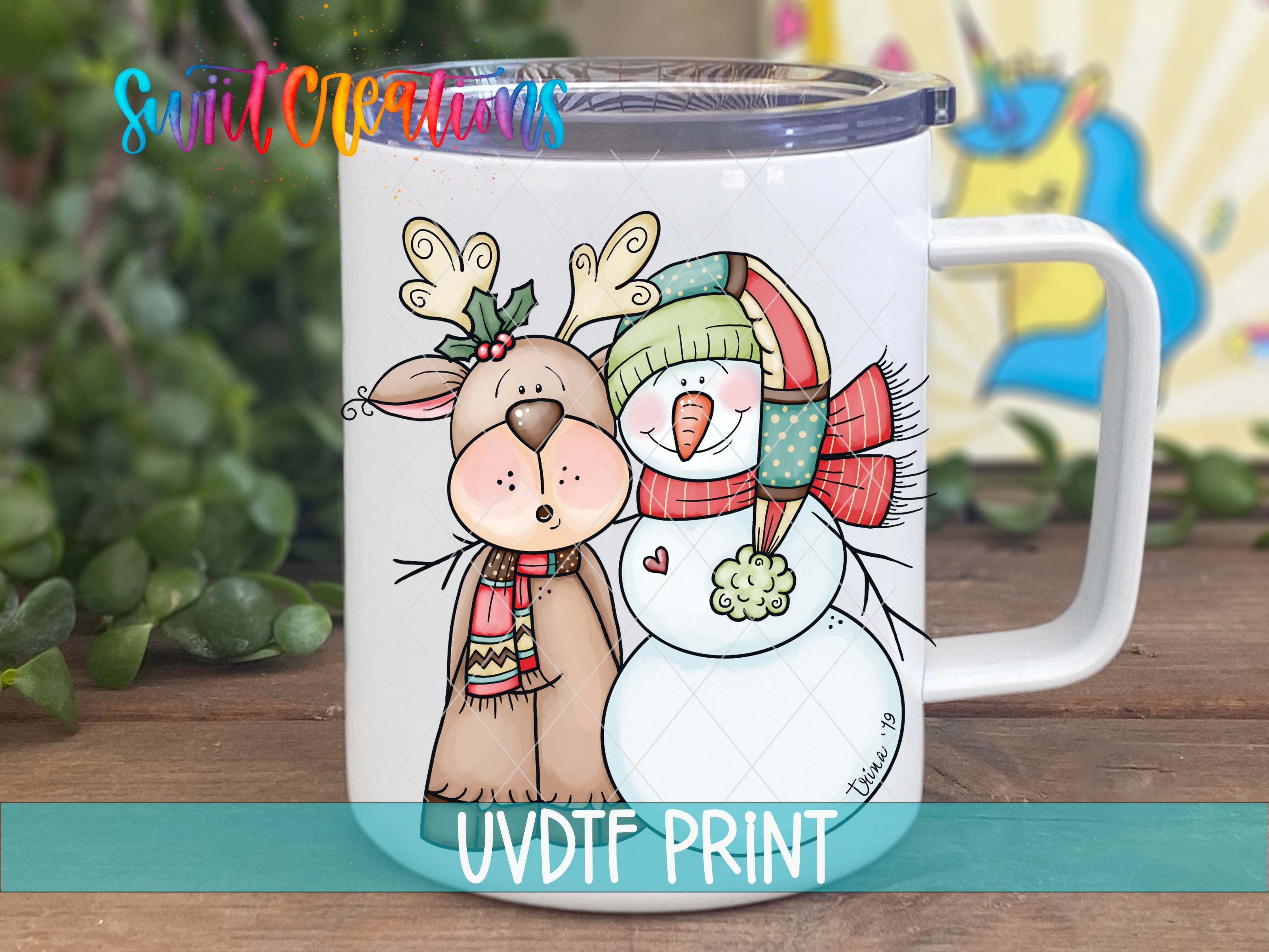 a white coffee mug with a picture of a snowman and a reindeer
