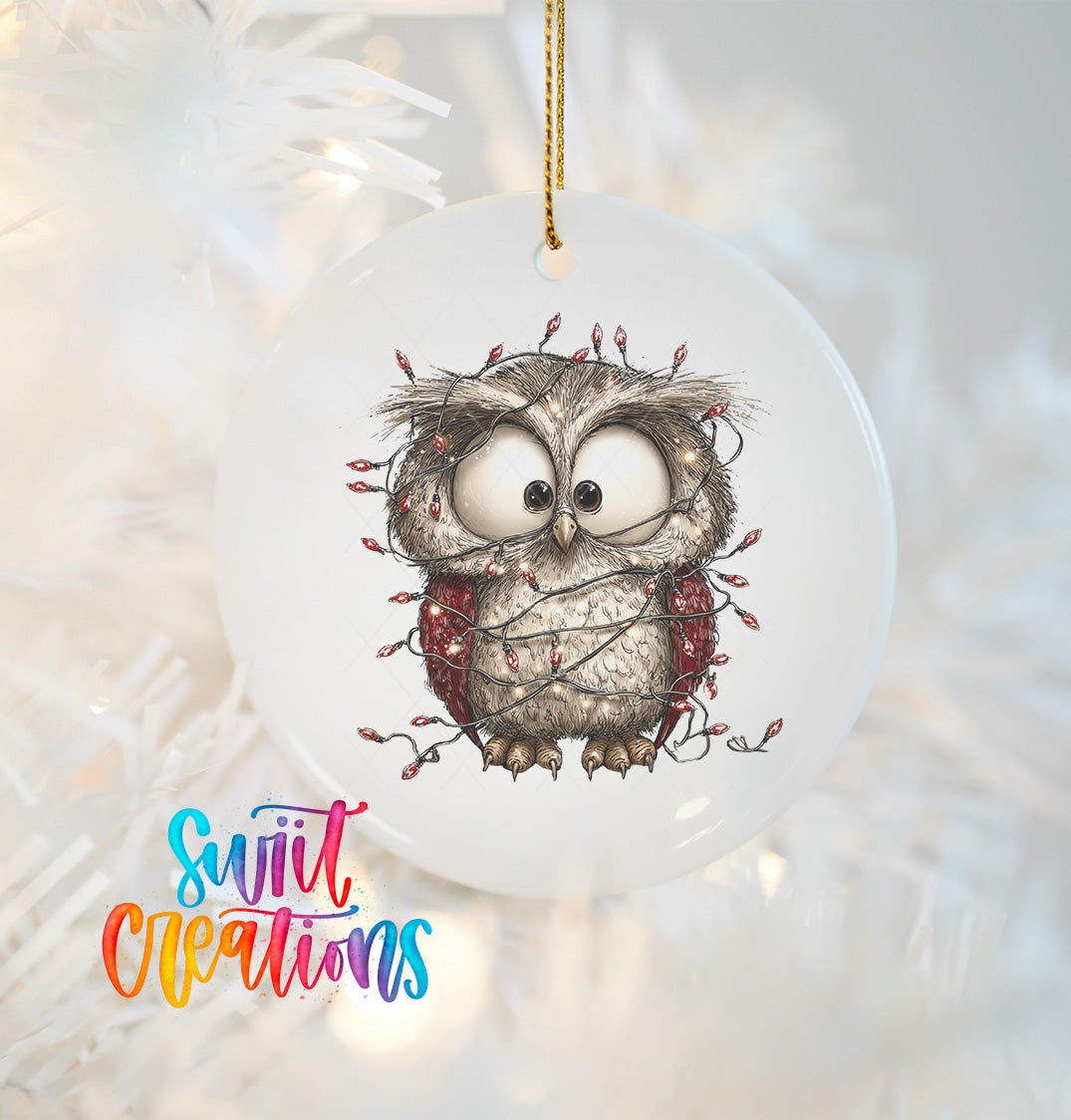 A ceramic ornament featuring a cartoon owl with a string of lights wrapped around it, hanging on a Christmas tree.
