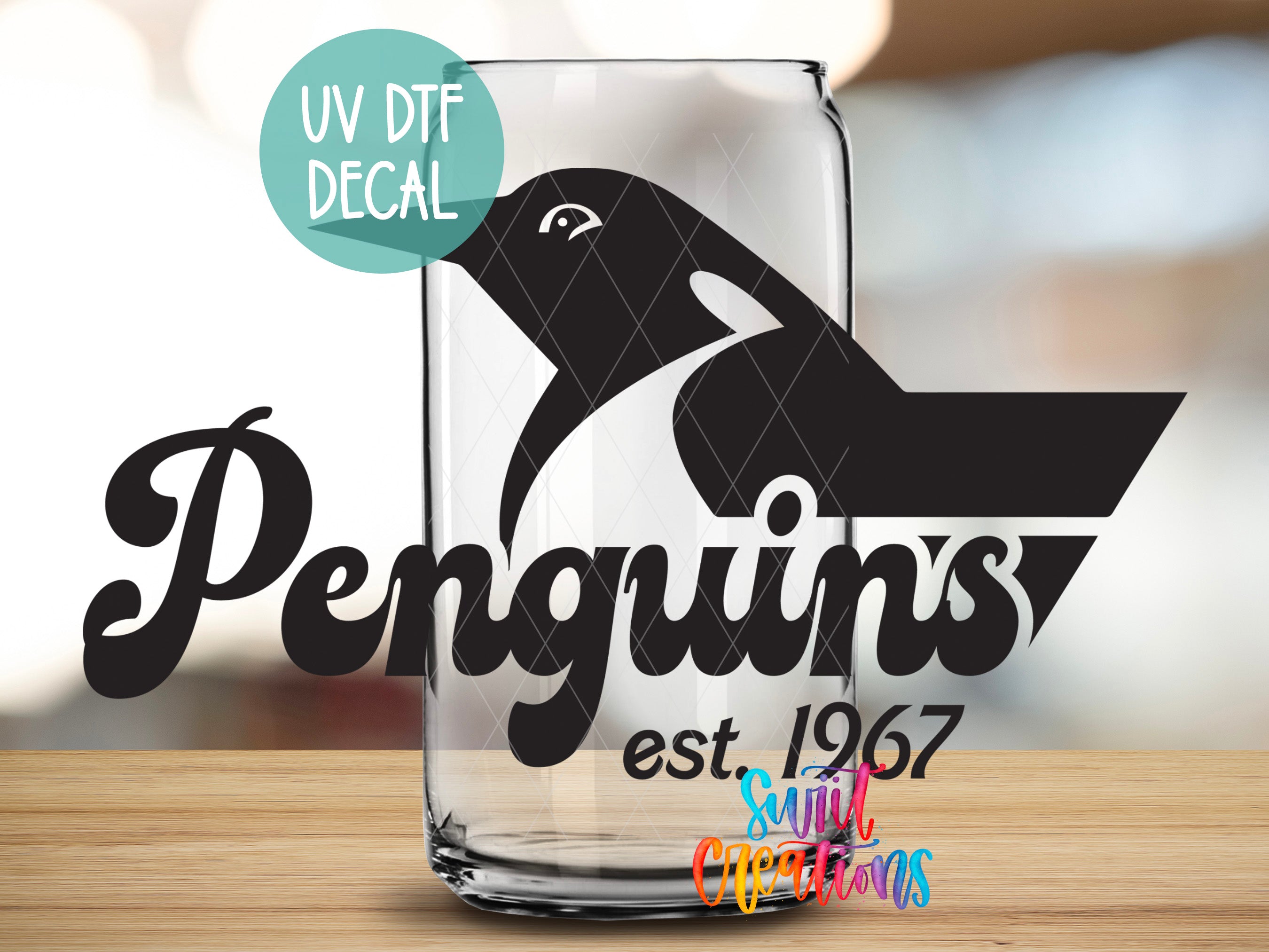 a glass with a picture of a penguin on it