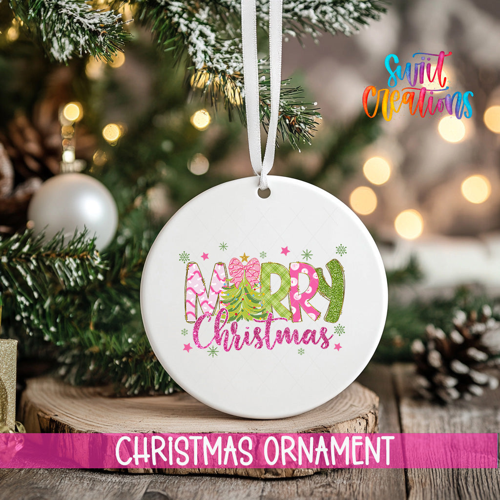 A white Christmas ornament with the text "Merry Christmas" is hanging on a tree branch, surrounded by pine cones and other holiday decorations.