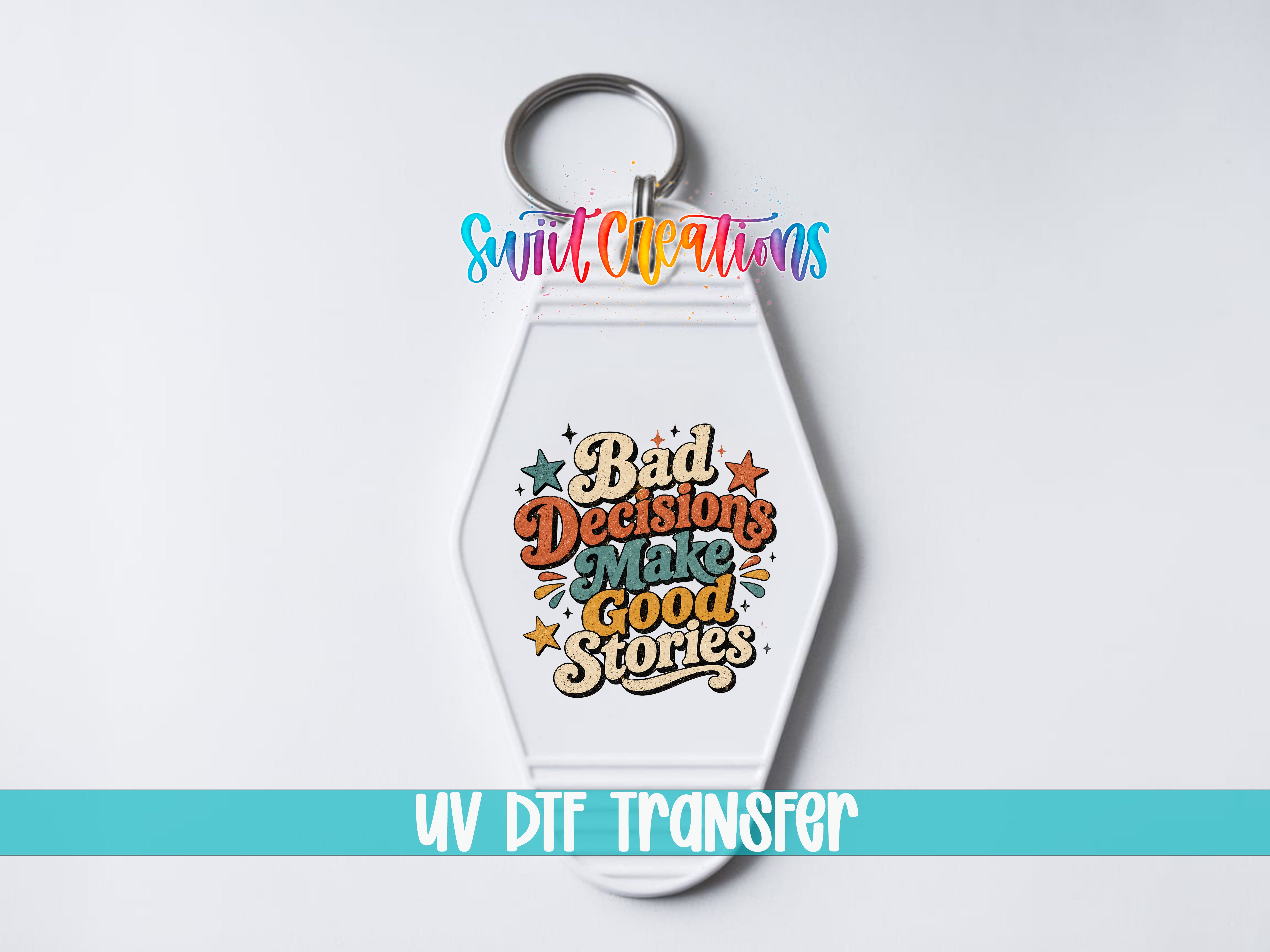 A keychain with a colorful graphic design and text that says "Bad Decisions Make Good Stories" and "UV DDF Transfer".
