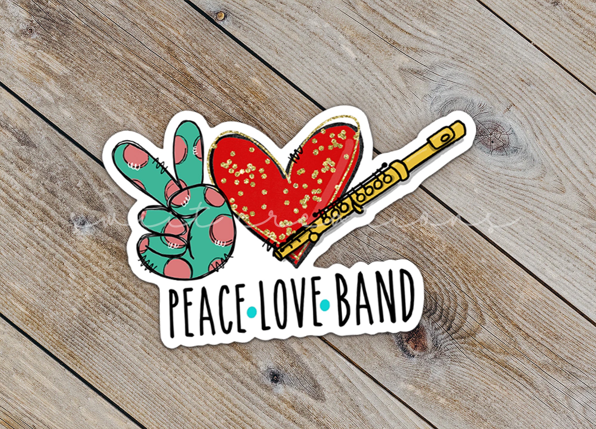 a peace love band sticker sitting on top of a wooden table