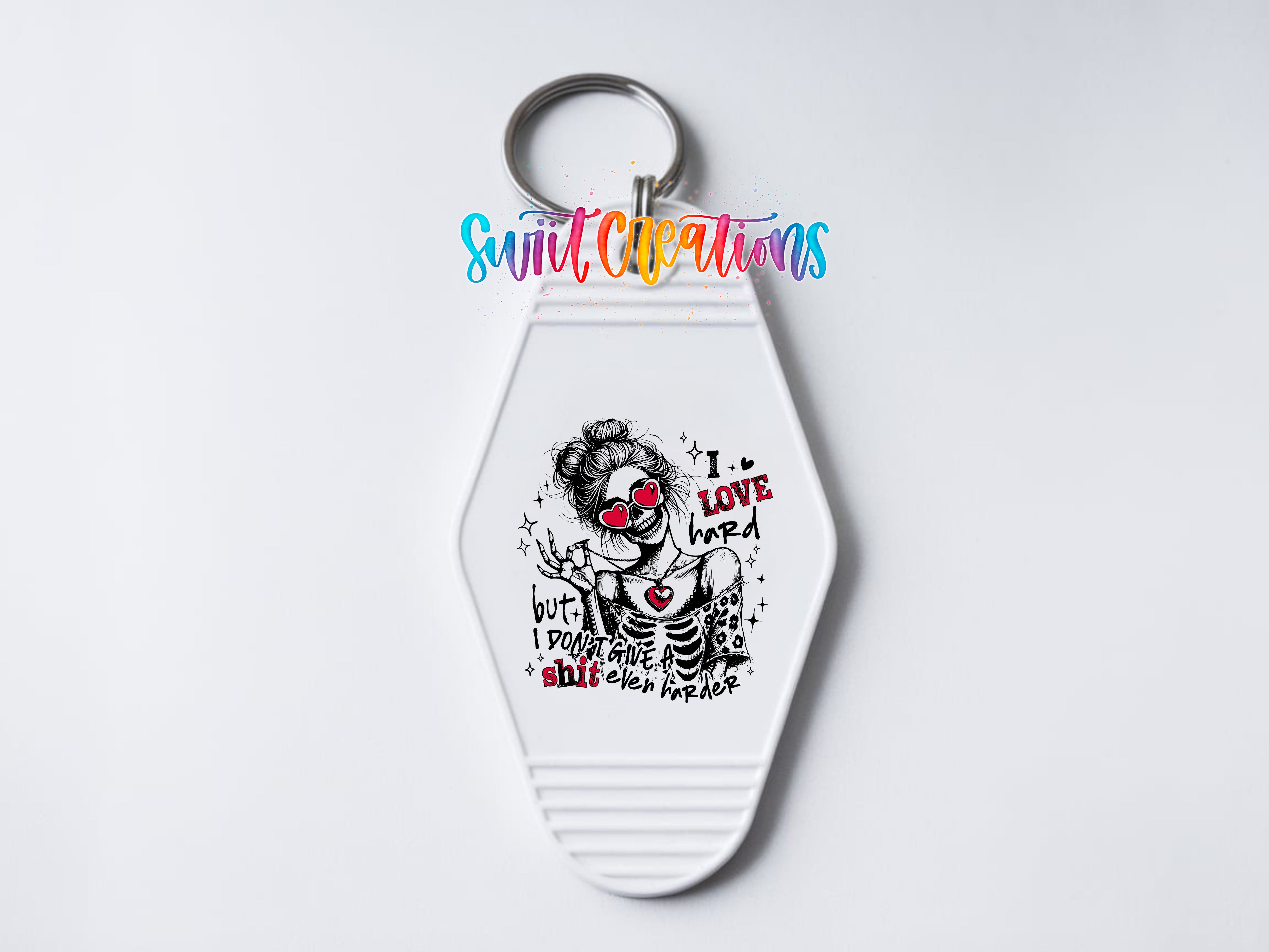 A keychain with a graphic design featuring a skeleton wearing sunglasses and the text "I love you" written on it.