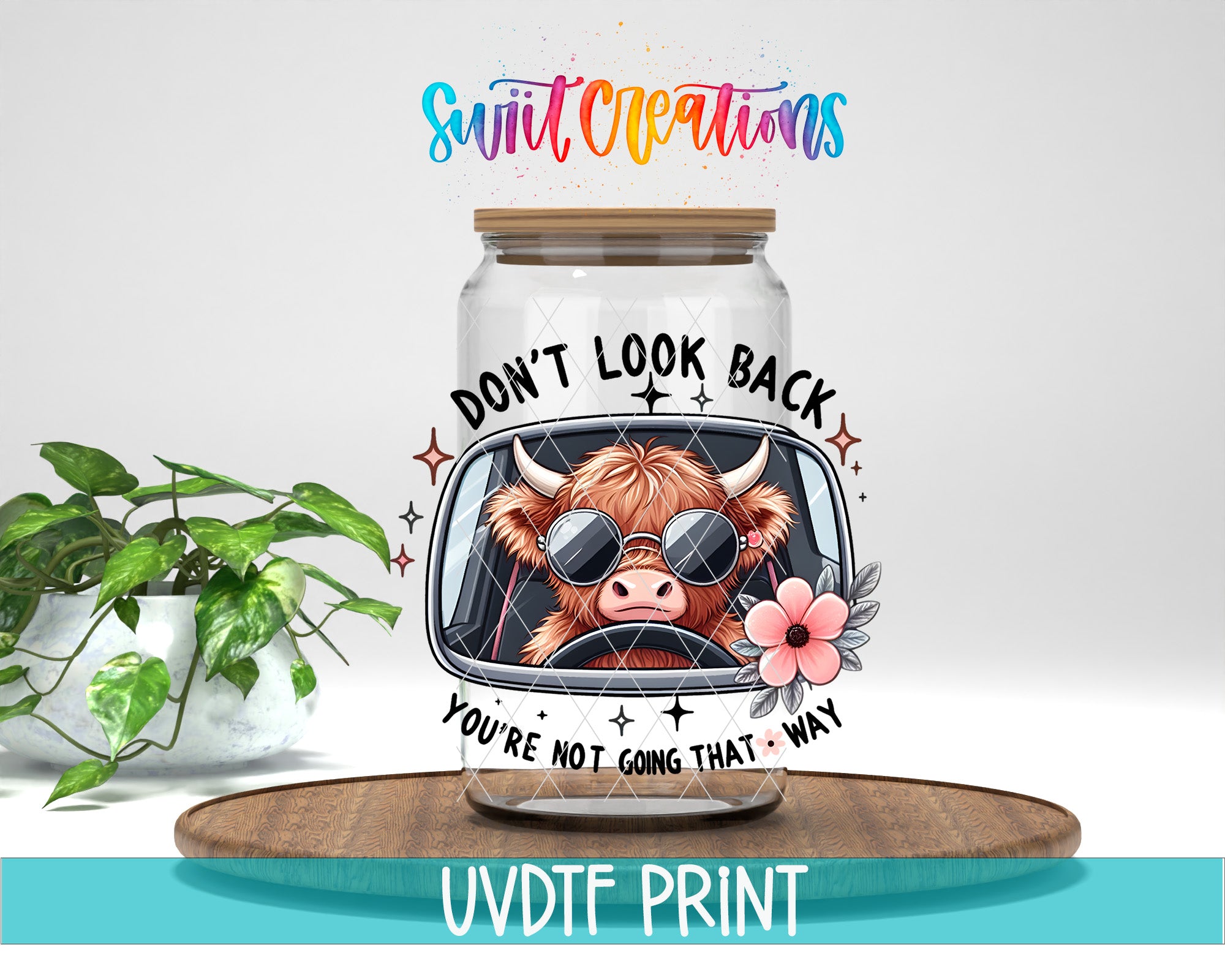 a glass jar with a cartoon cow wearing sunglasses and a flower, along with the text "DON'T LOOK BACK YOU'RE NOT GOING THAT WAY" printed on it.