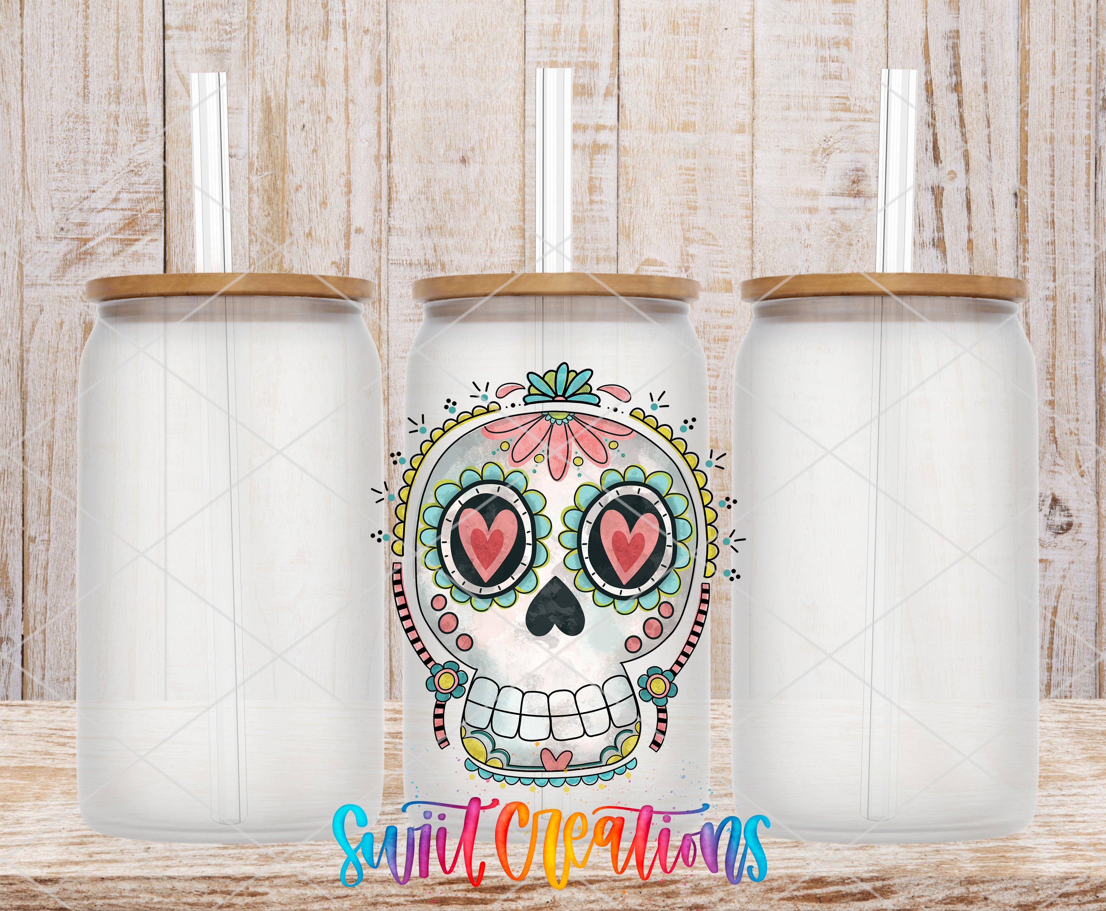 A colorful ceramic mug with a skull design and a straw, placed on a wooden surface.