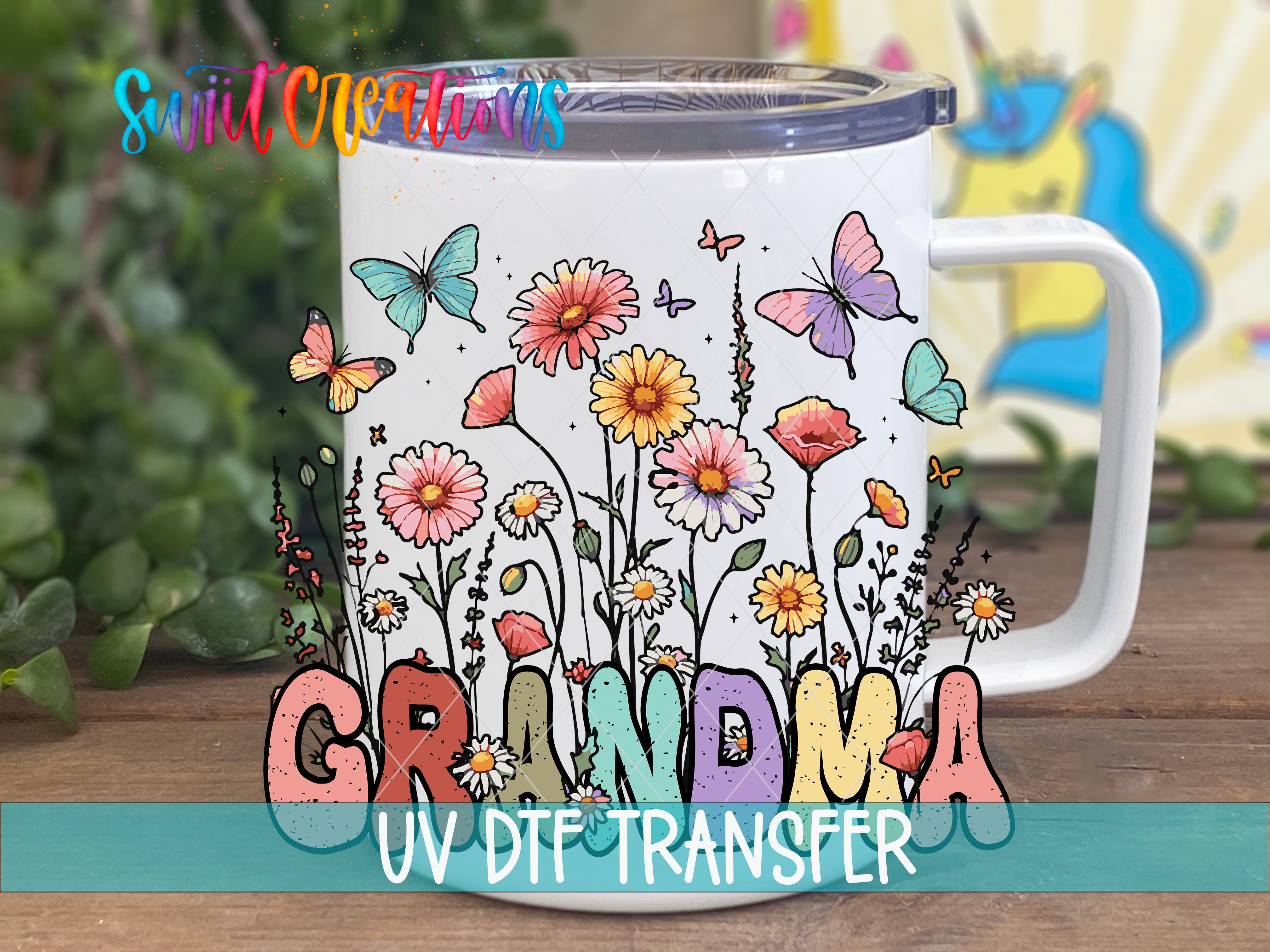 A white mug with a colorful floral design and the word "GRANDMA" printed on it, along with the text "UV DFT Transfer".