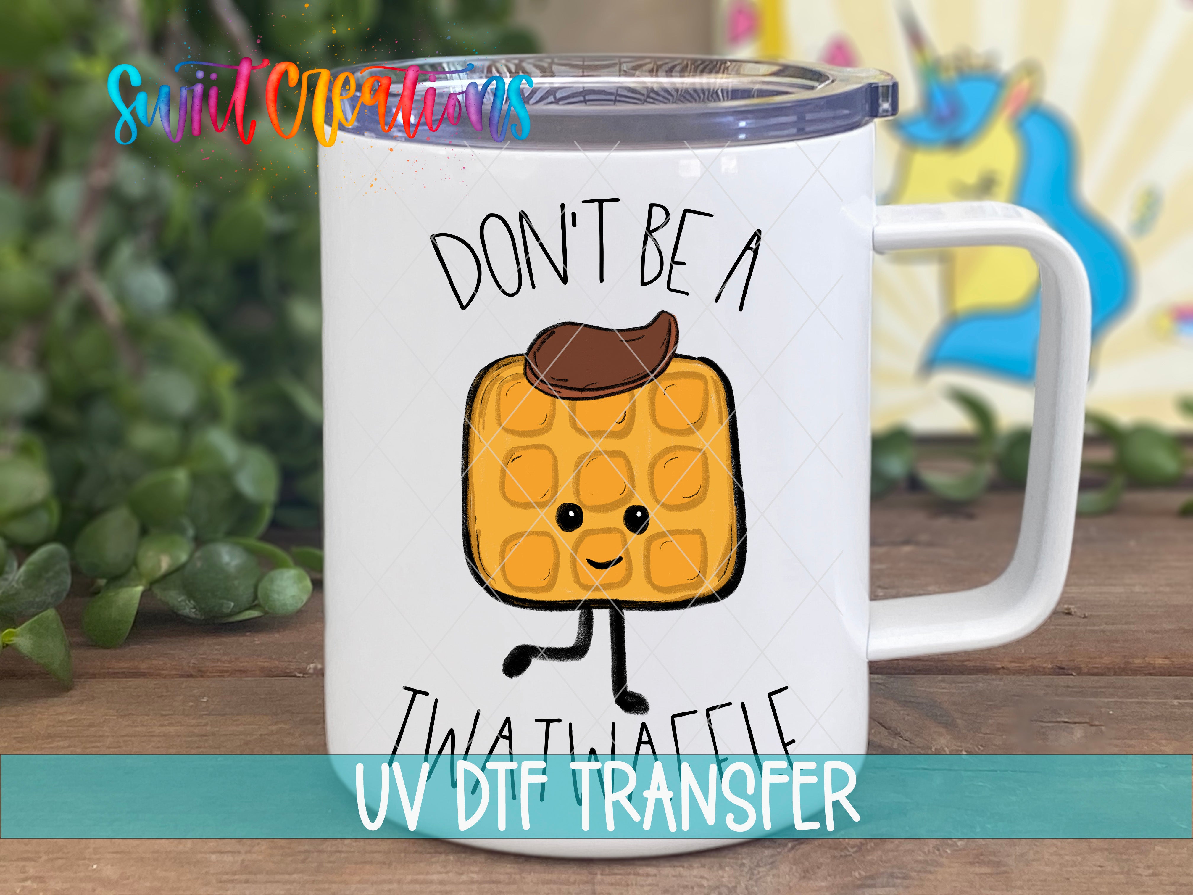 A white mug with a cartoon image of a waffle and the text "DON'T BE A TWAT Waffle" printed on it.