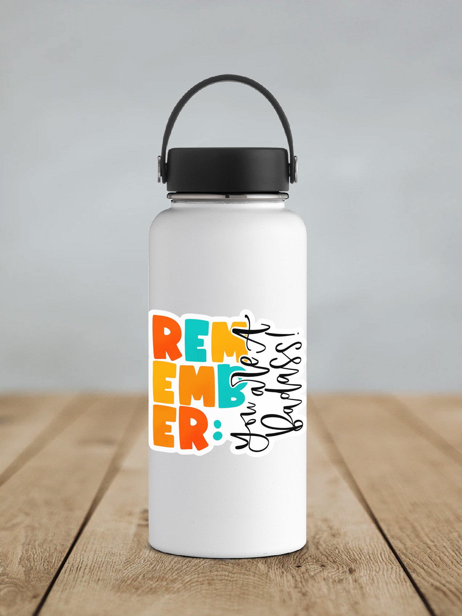 a white water bottle with a black lid on a wooden table