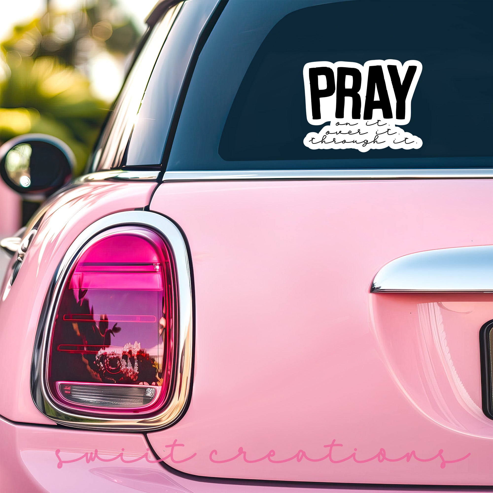 a pink car with a sticker that says pray