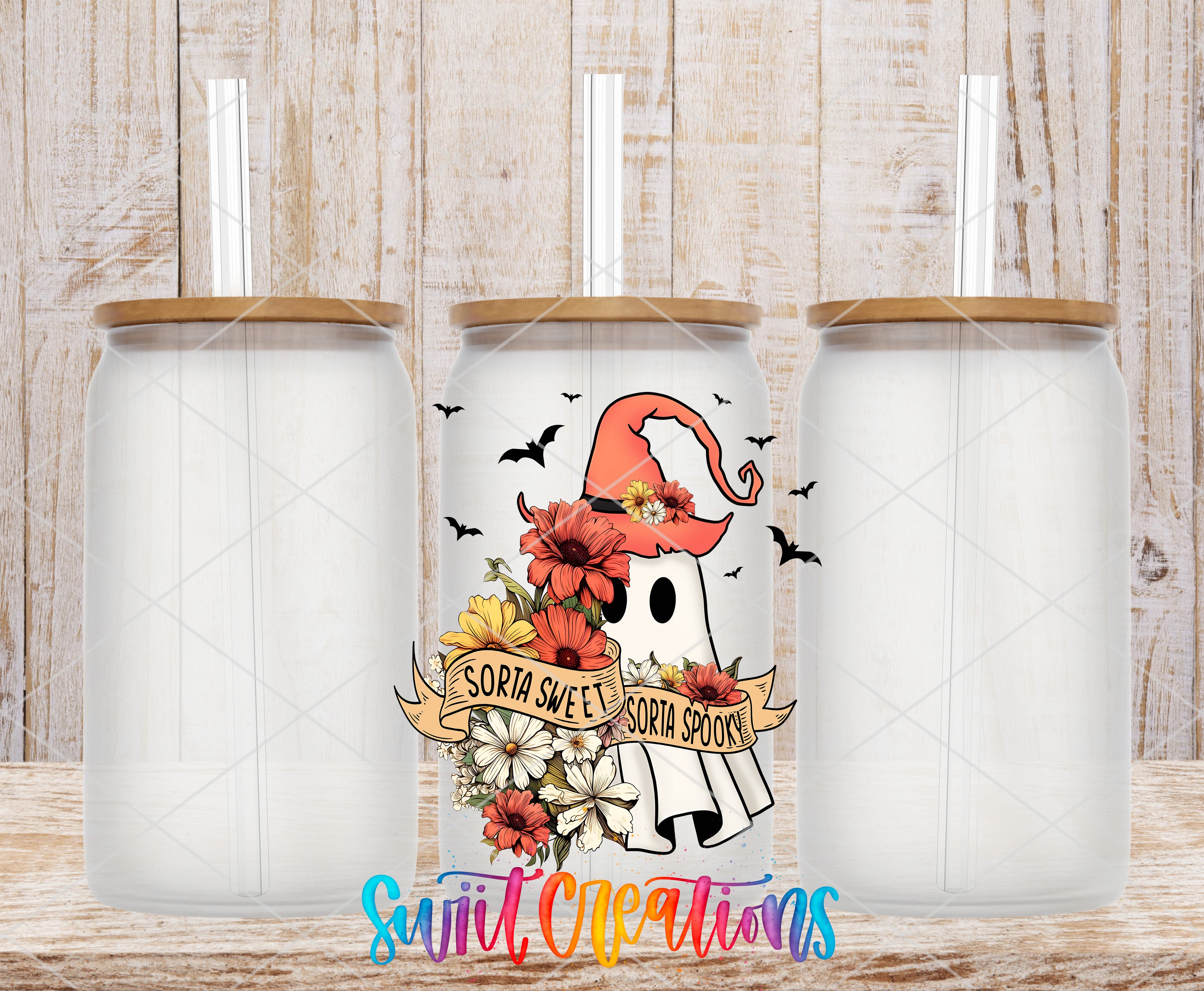 three clear glass jars with lids, each containing a straw. The jars are arranged in a row, and there is a colorful design on the front of one of the jars that includes a ghost, flowers, and the text "SORIA SWEET SORIA SPOOKY".