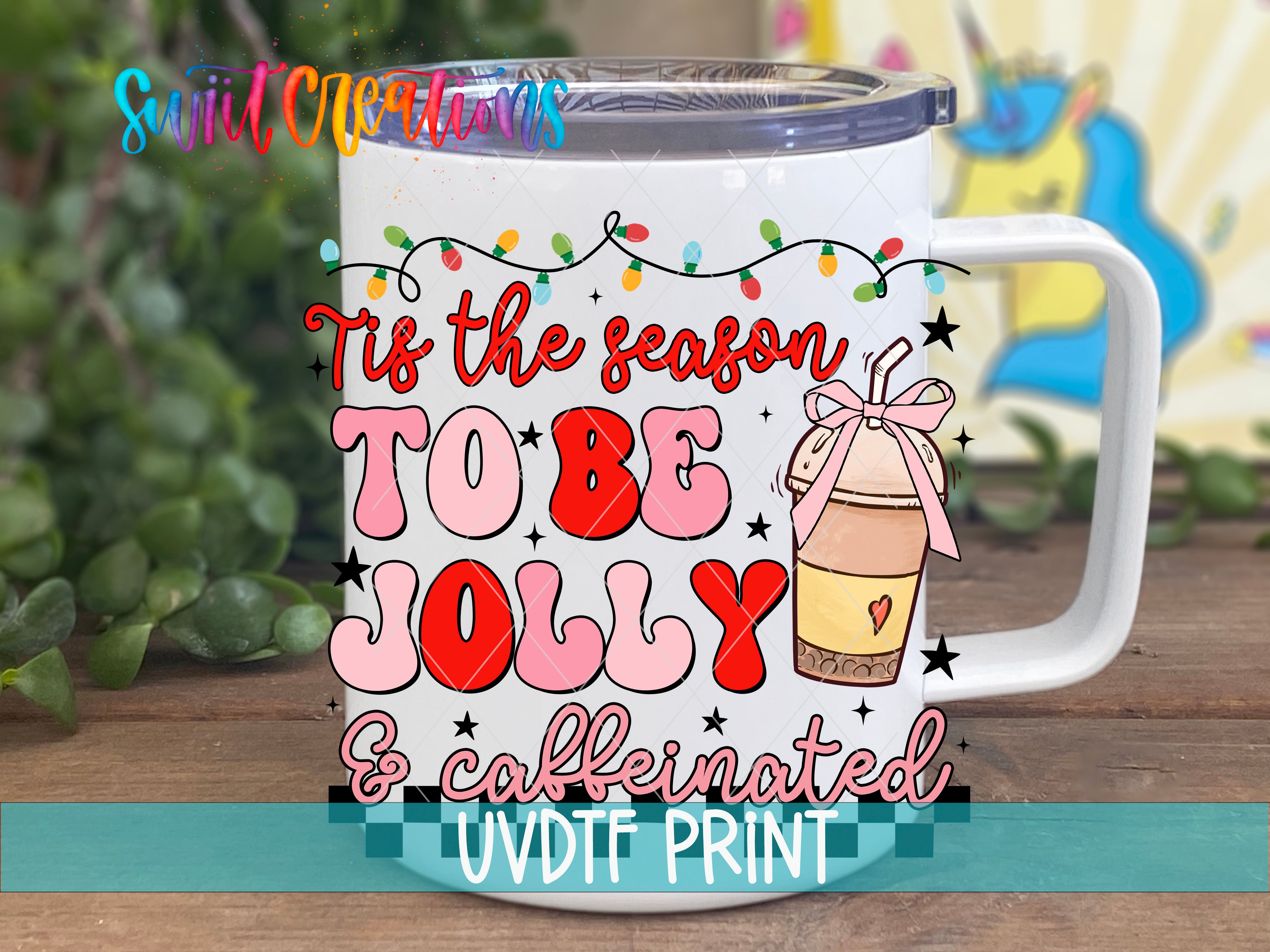 a white coffee mug with the words tis the season to be jolly and cookie