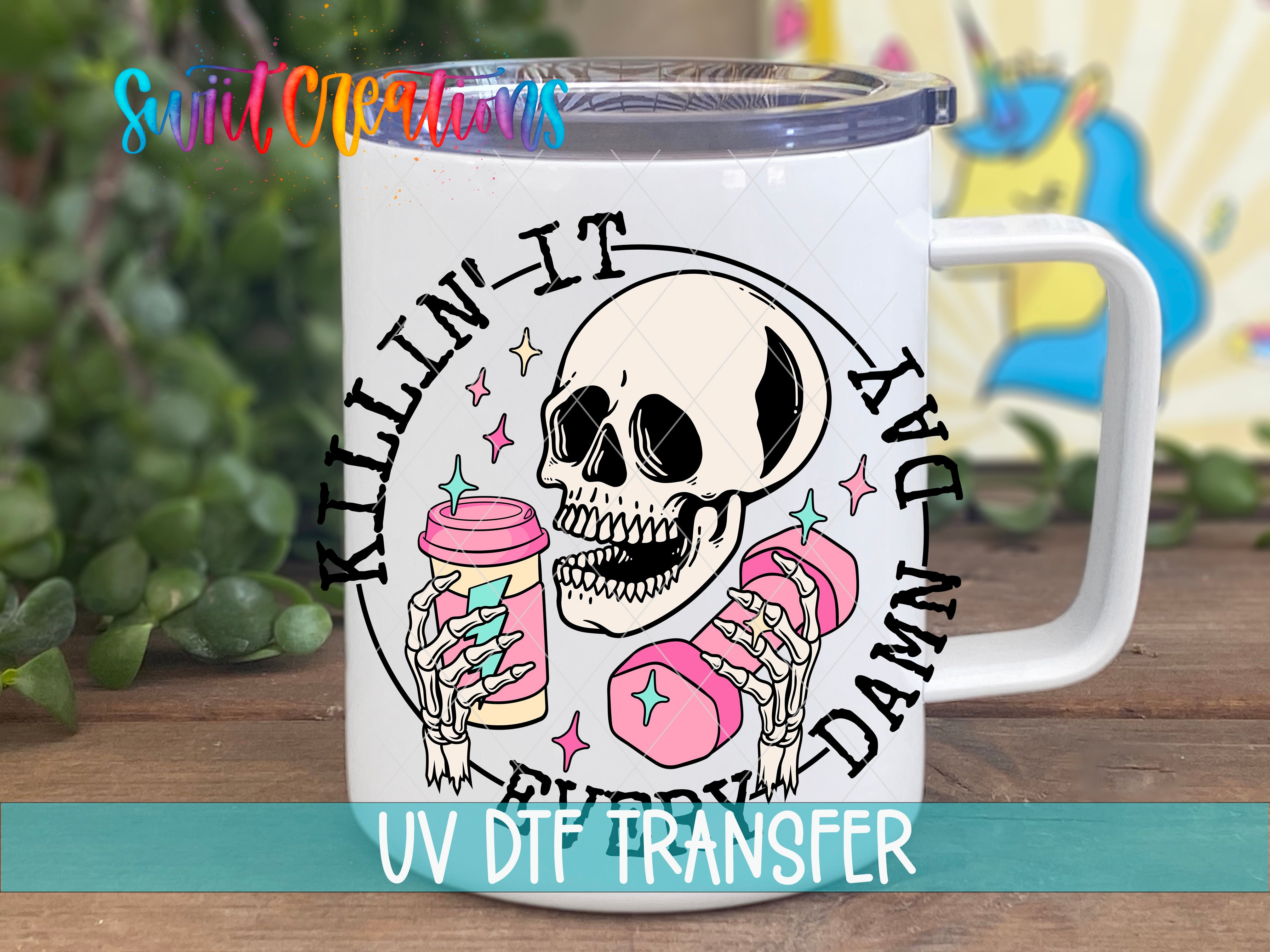 A white mug with a skull design and text printed on it, along with a plant in the background.