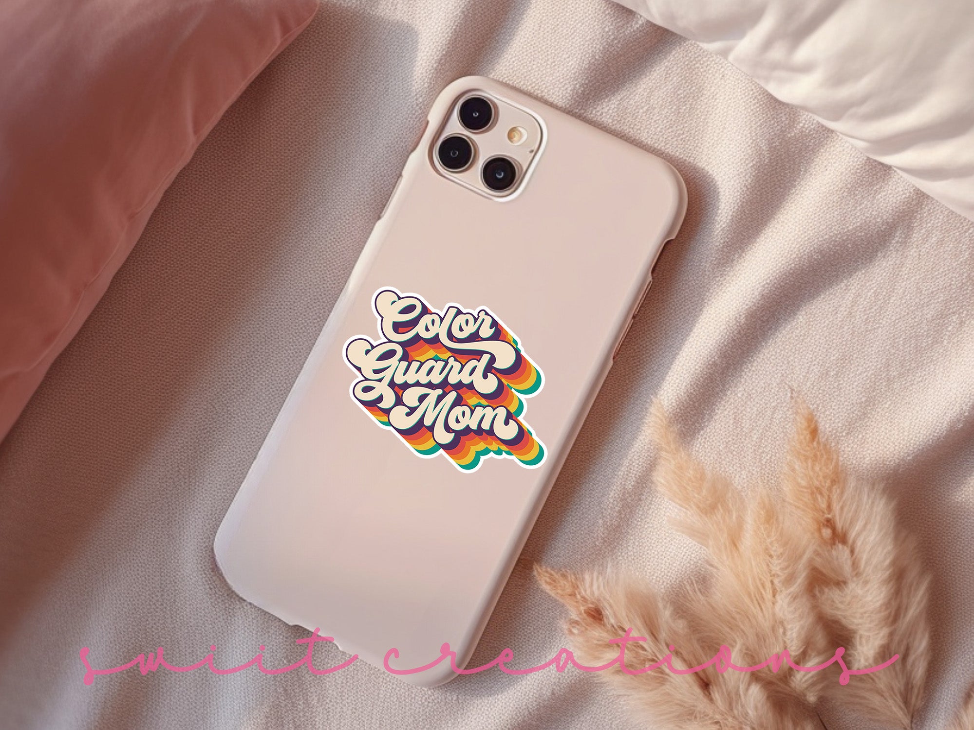 a phone case with a sticker on it sitting on a bed