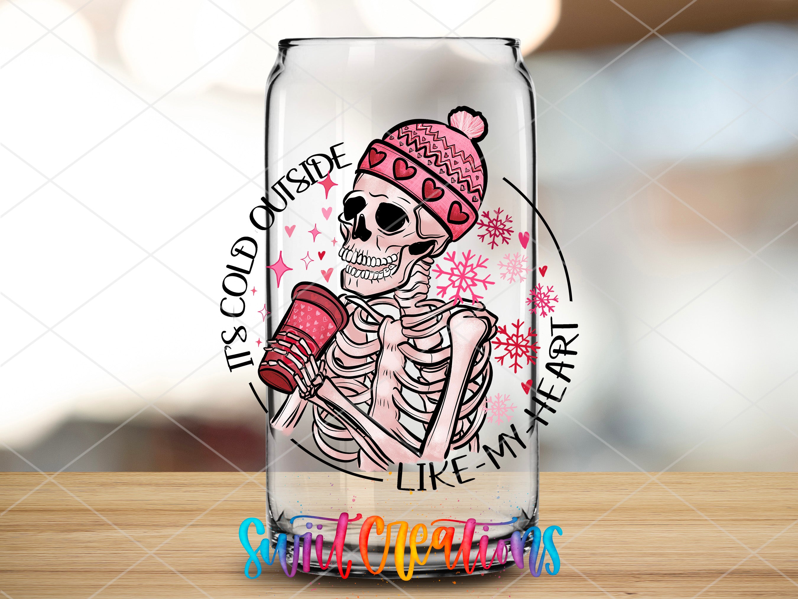 a glass with a skeleton holding a cup