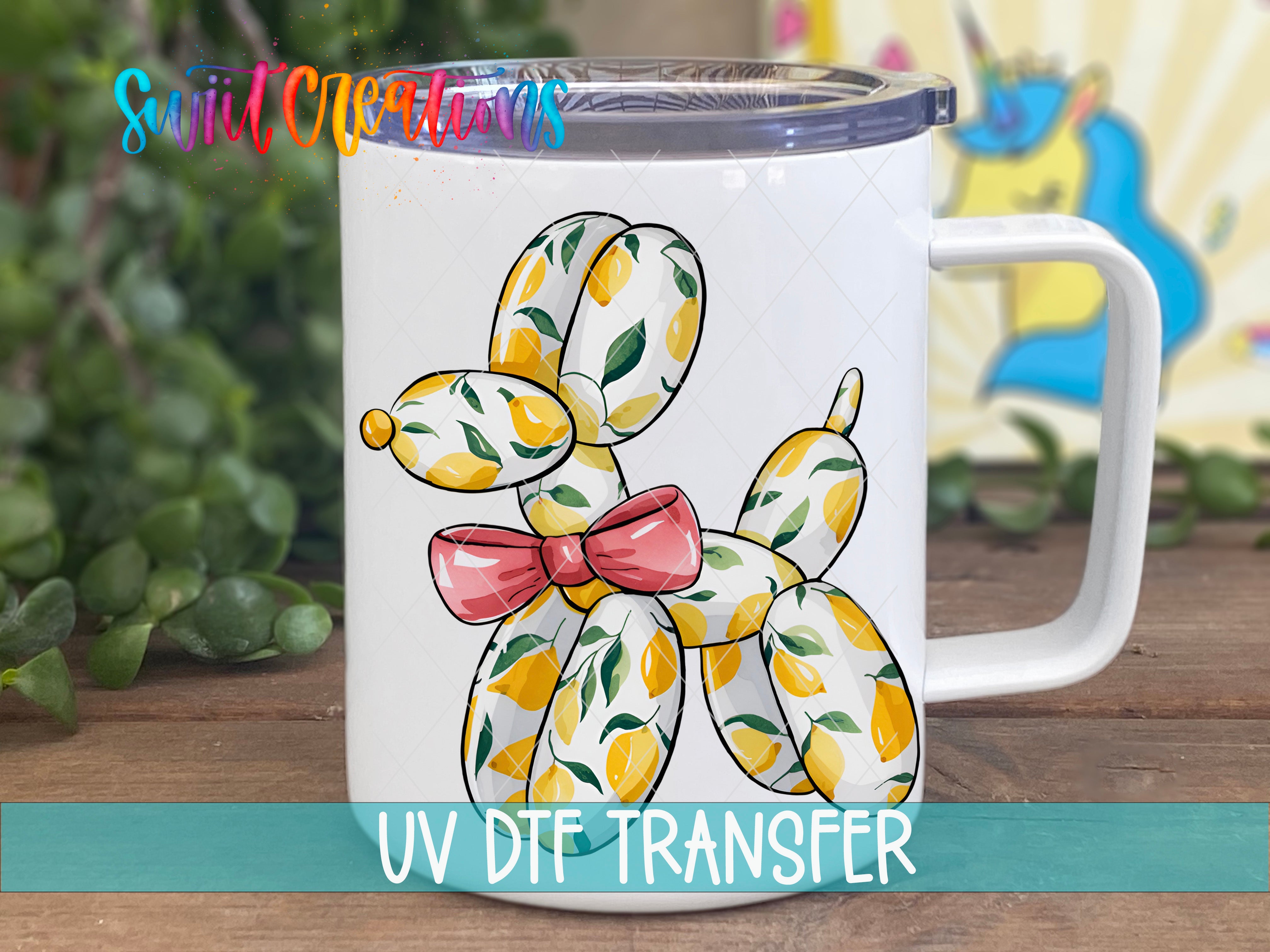 A white mug with a colorful illustration of a balloon dog on it, placed on a wooden surface.