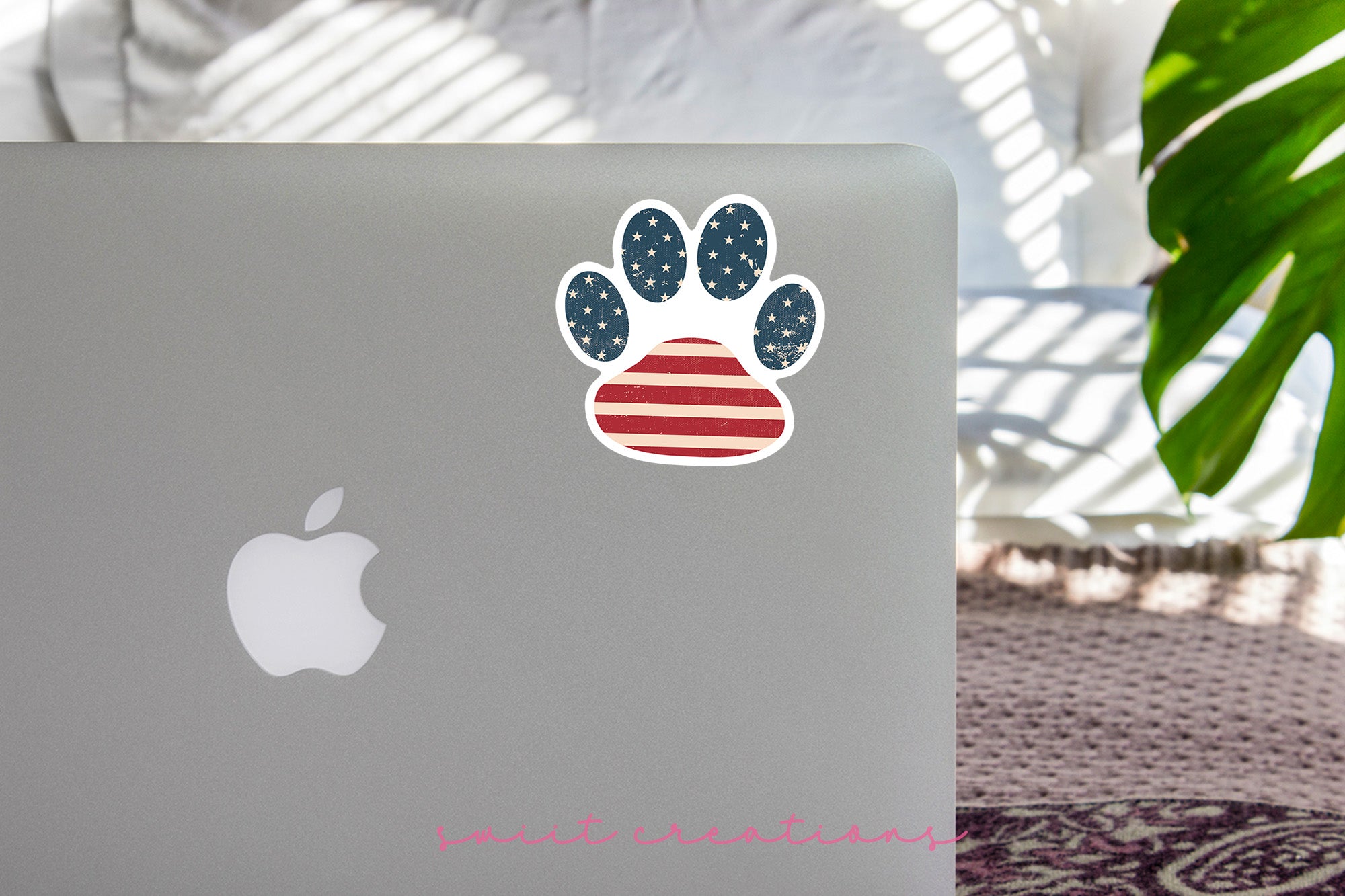 a laptop with an american flag paw sticker on it