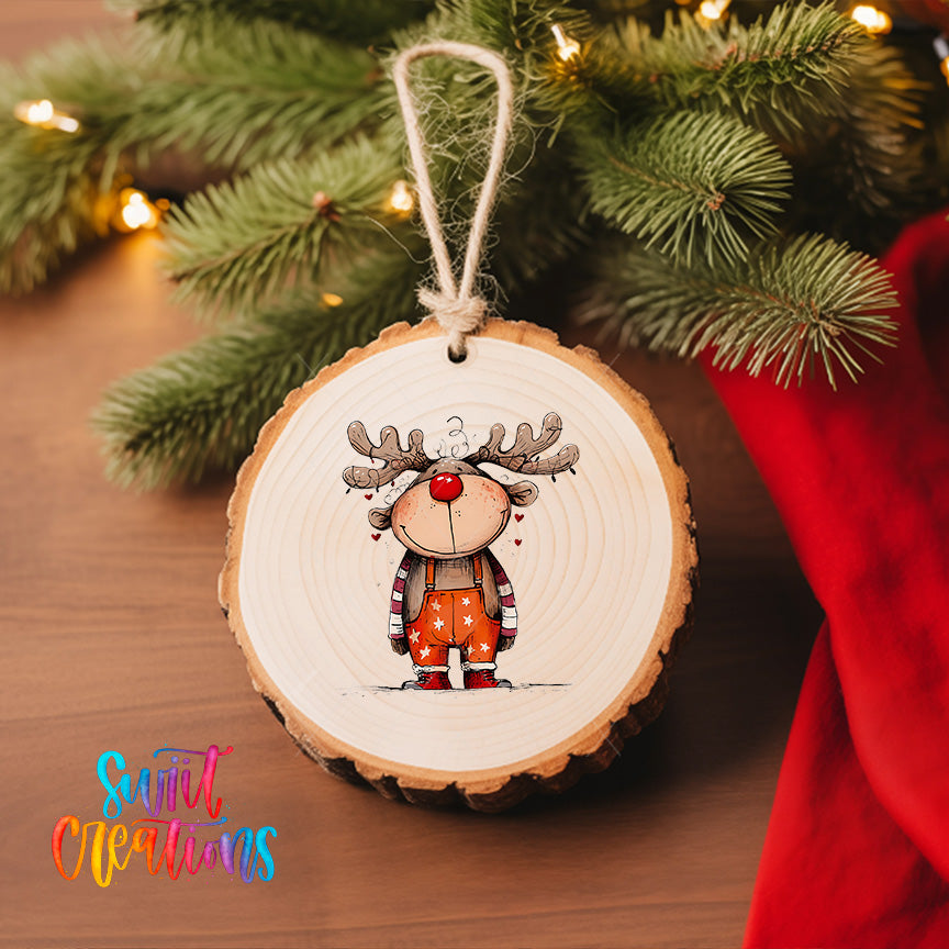 A wooden ornament featuring a cartoon reindeer is hanging on a Christmas tree, surrounded by pine branches and twinkling lights.