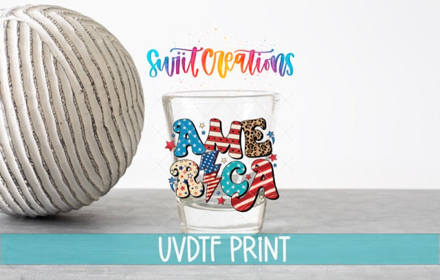 a ball of yarn next to a shot glass
