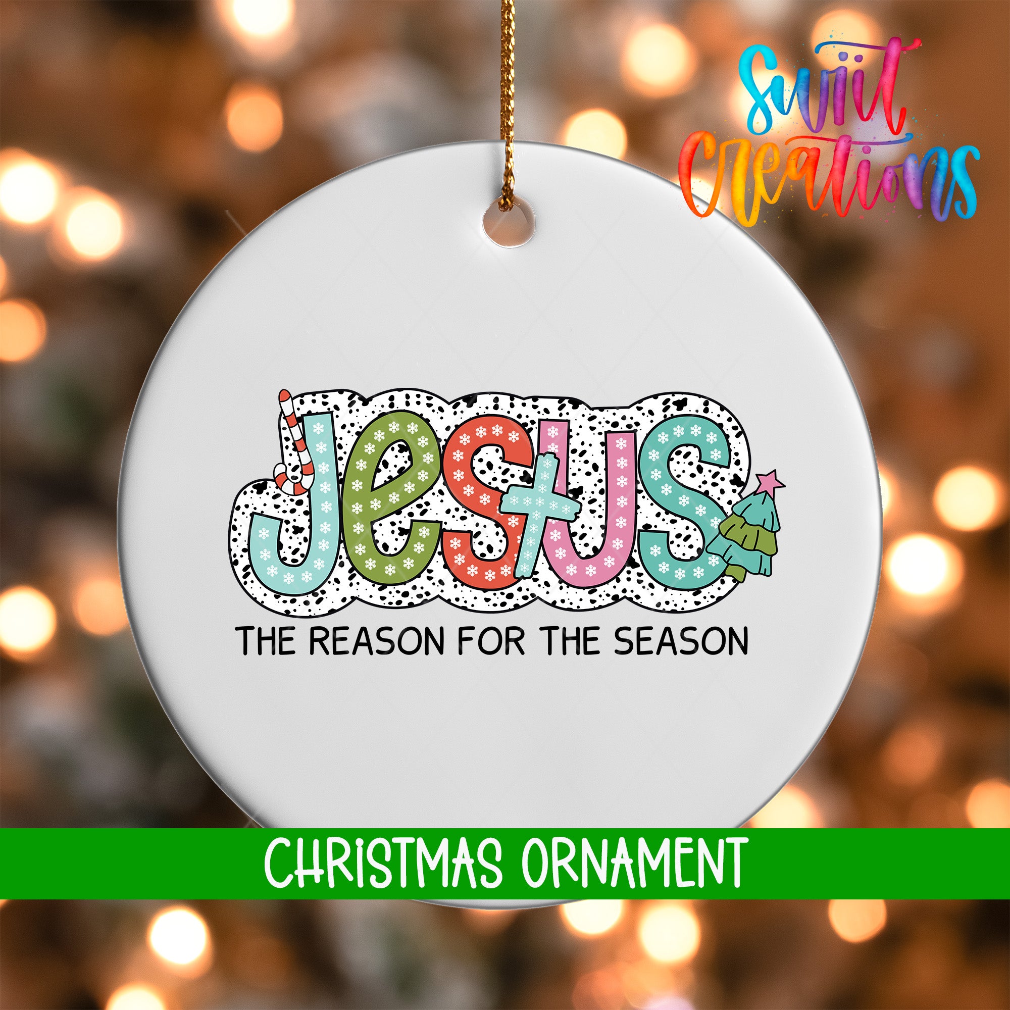 A white Christmas ornament with the word "JESUS" written in colorful letters, along with the text "THE REASON FOR THE SEASON" below it.