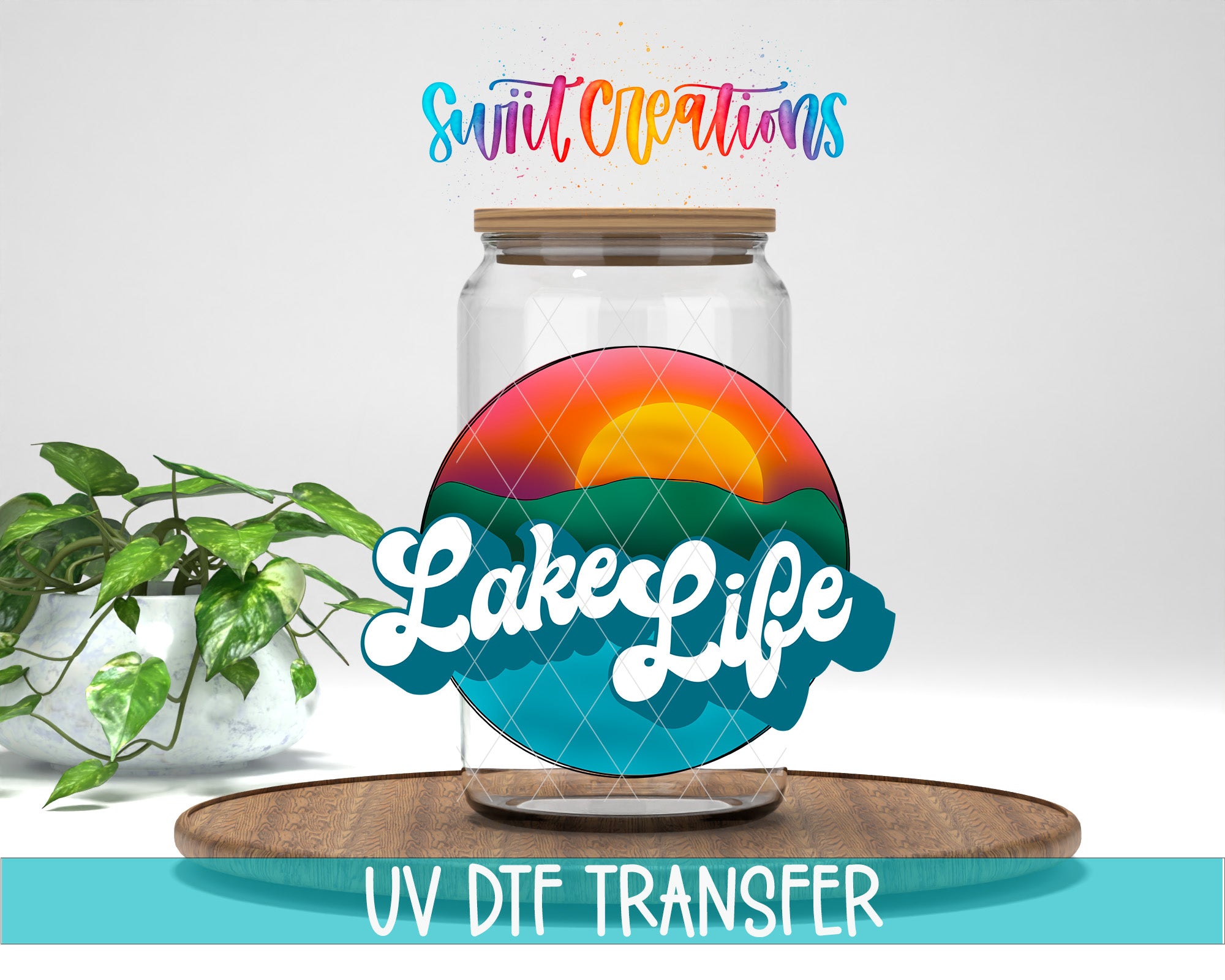 a glass jar with a colorful design, placed on a wooden surface, with a potted plant in the background.