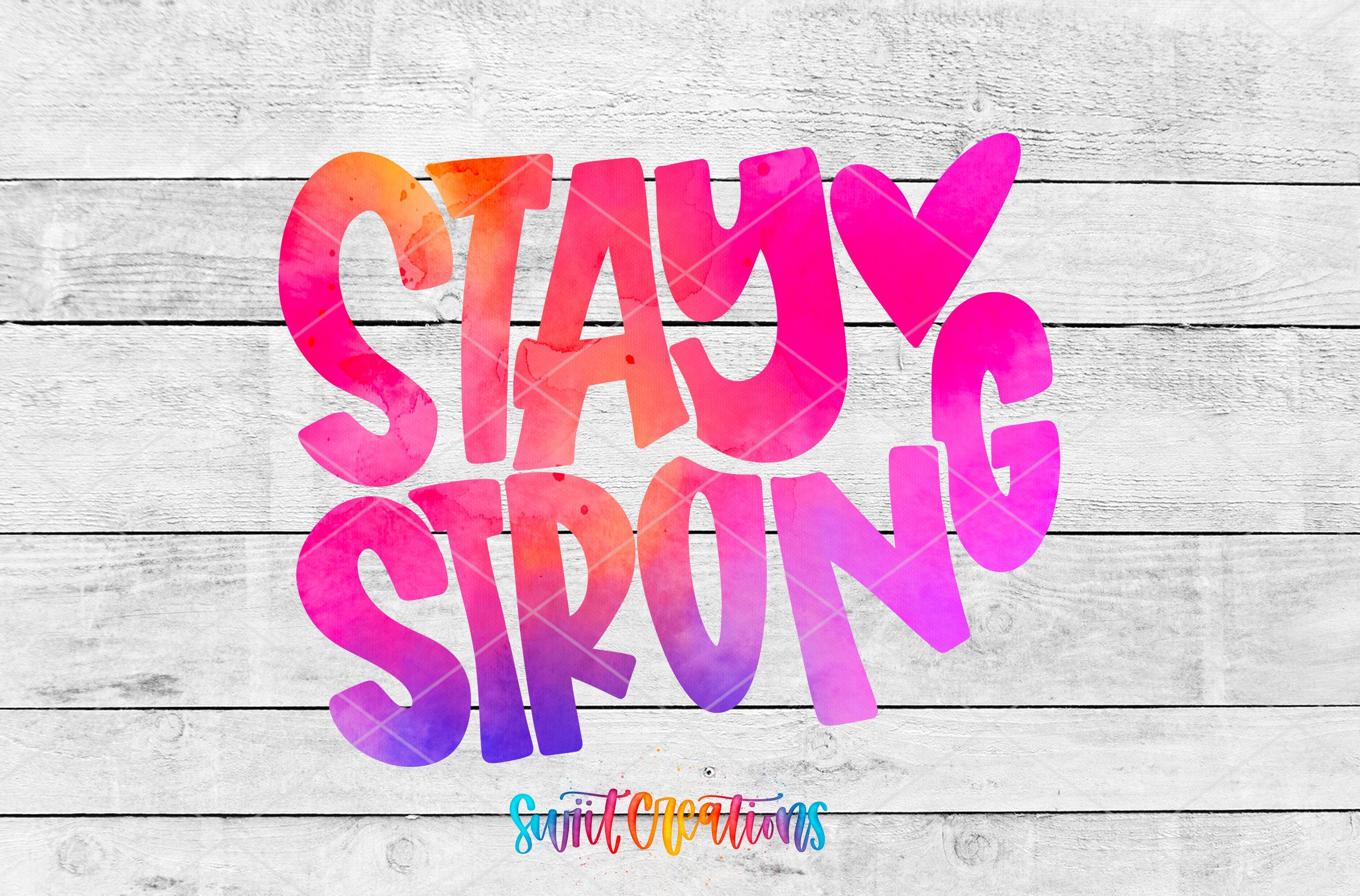 the words stay strong are painted on a wooden background