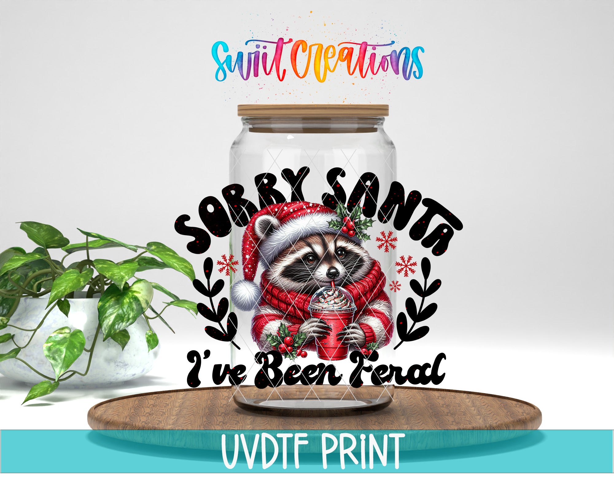 A glass jar with a raccoon wearing a Santa hat and holding a cup of hot chocolate, surrounded by snowflakes and the text "Sorry Santa I've Been Teral"