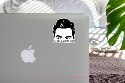 a laptop with a sticker of a man's face