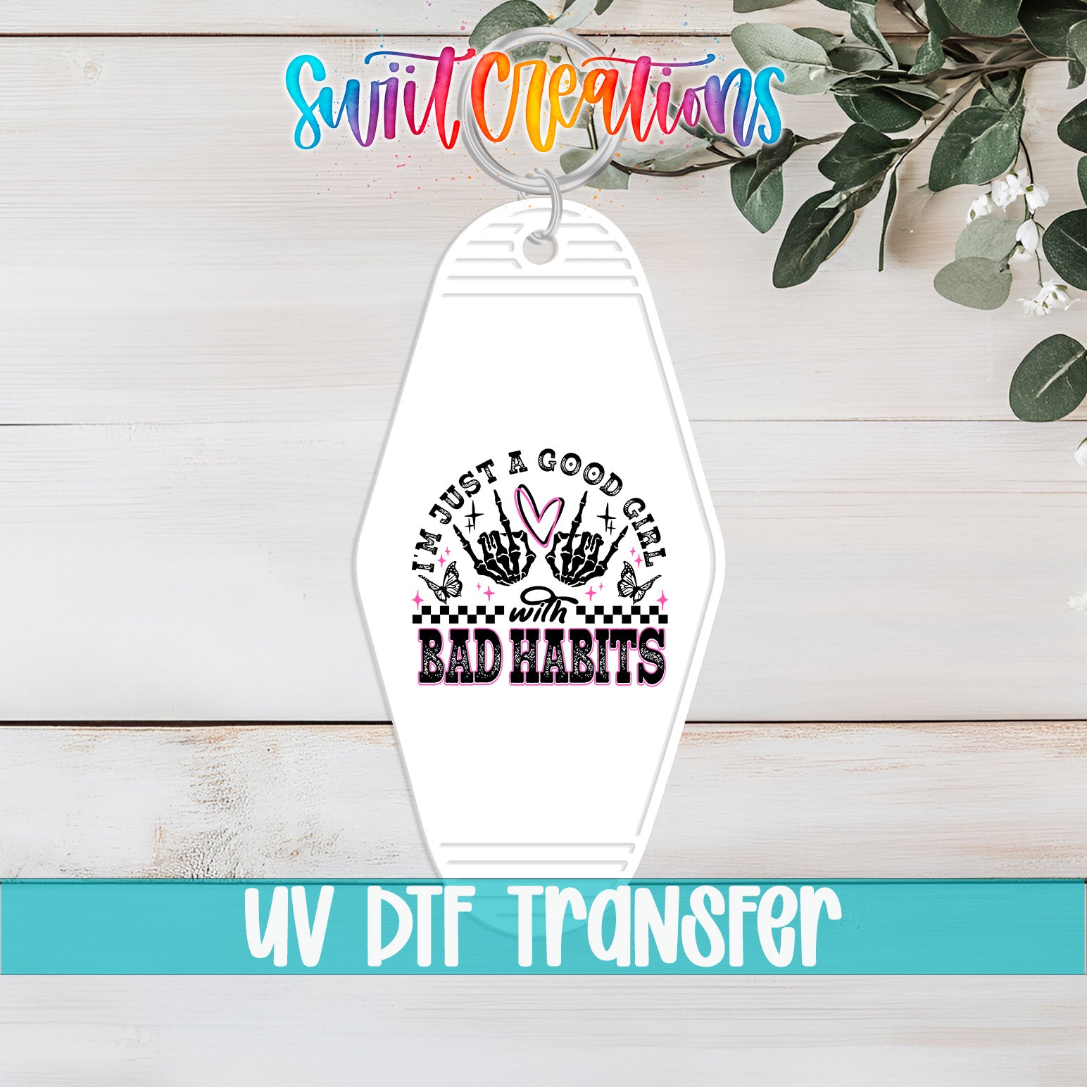 A keychain with a design featuring a skull and crossbones symbol, surrounded by text that reads "I'm just a good girl with bad habits".