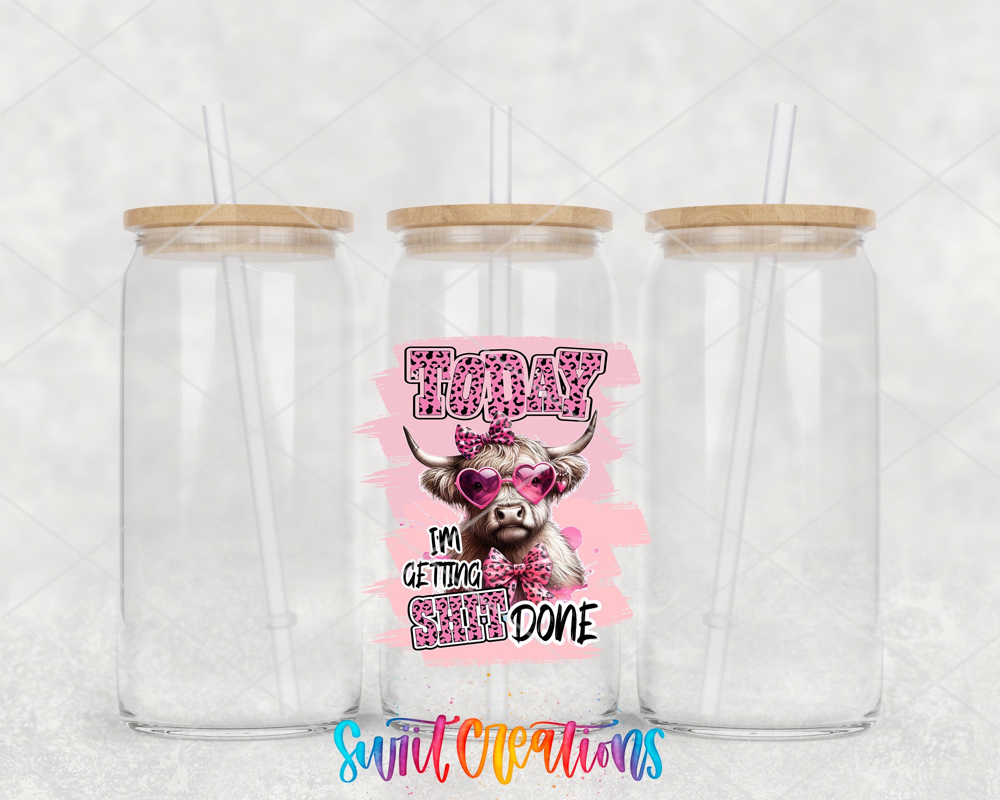 two clear tumblers with a cow on the side