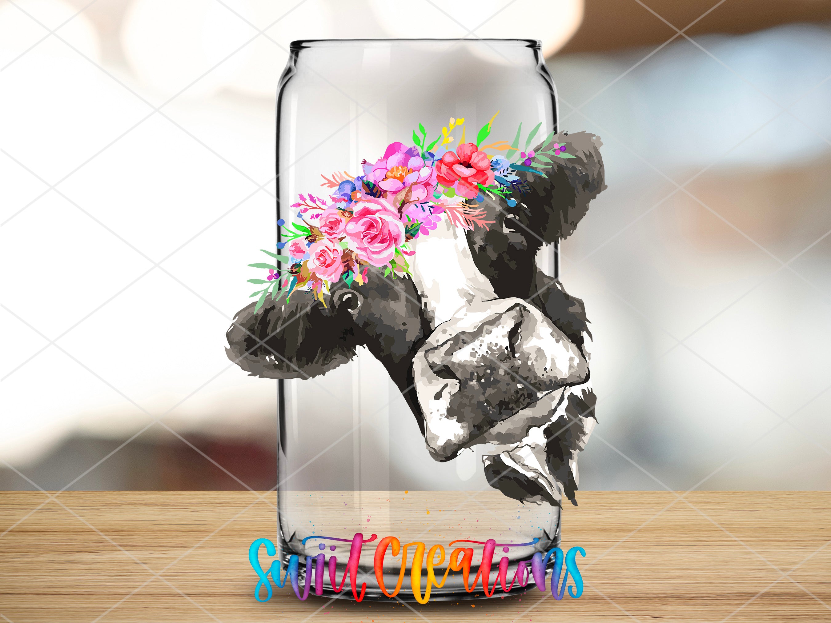 a glass vase with a cow and flowers in it