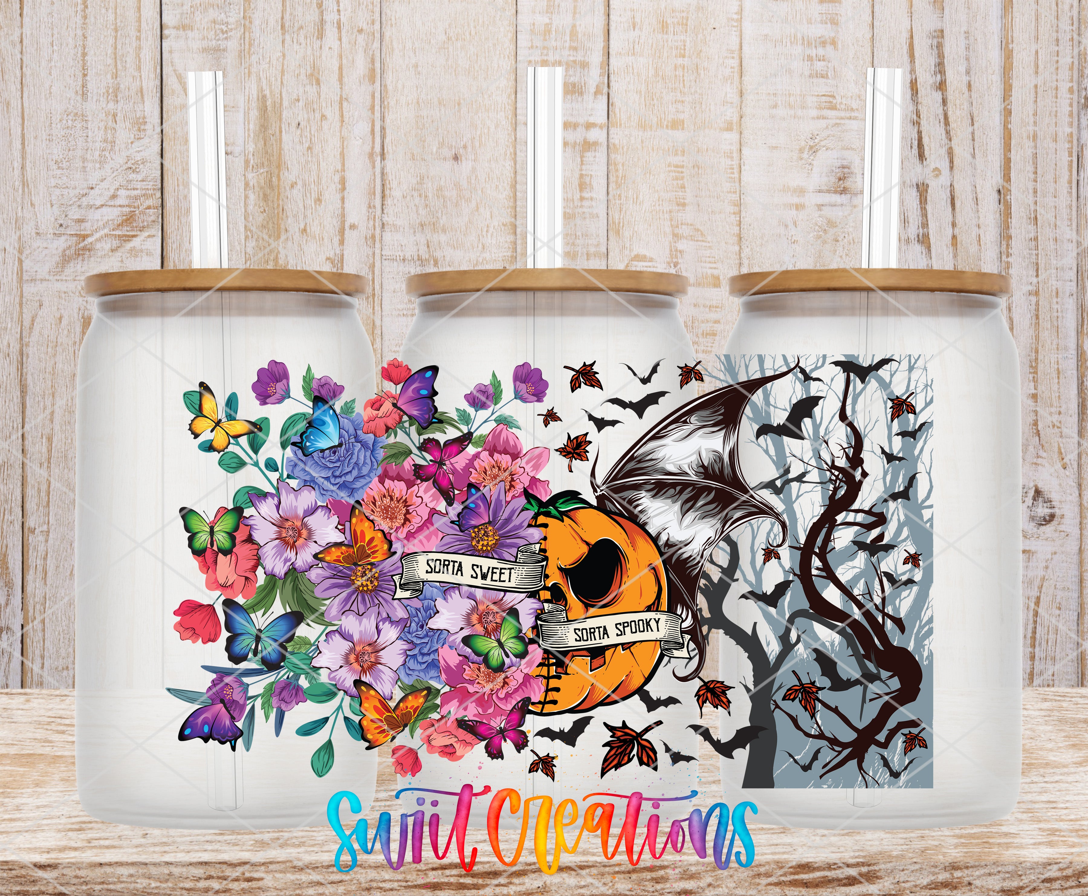 three glass jars with colorful floral designs and Halloween-themed illustrations, including bats, pumpkins, and butterflies.