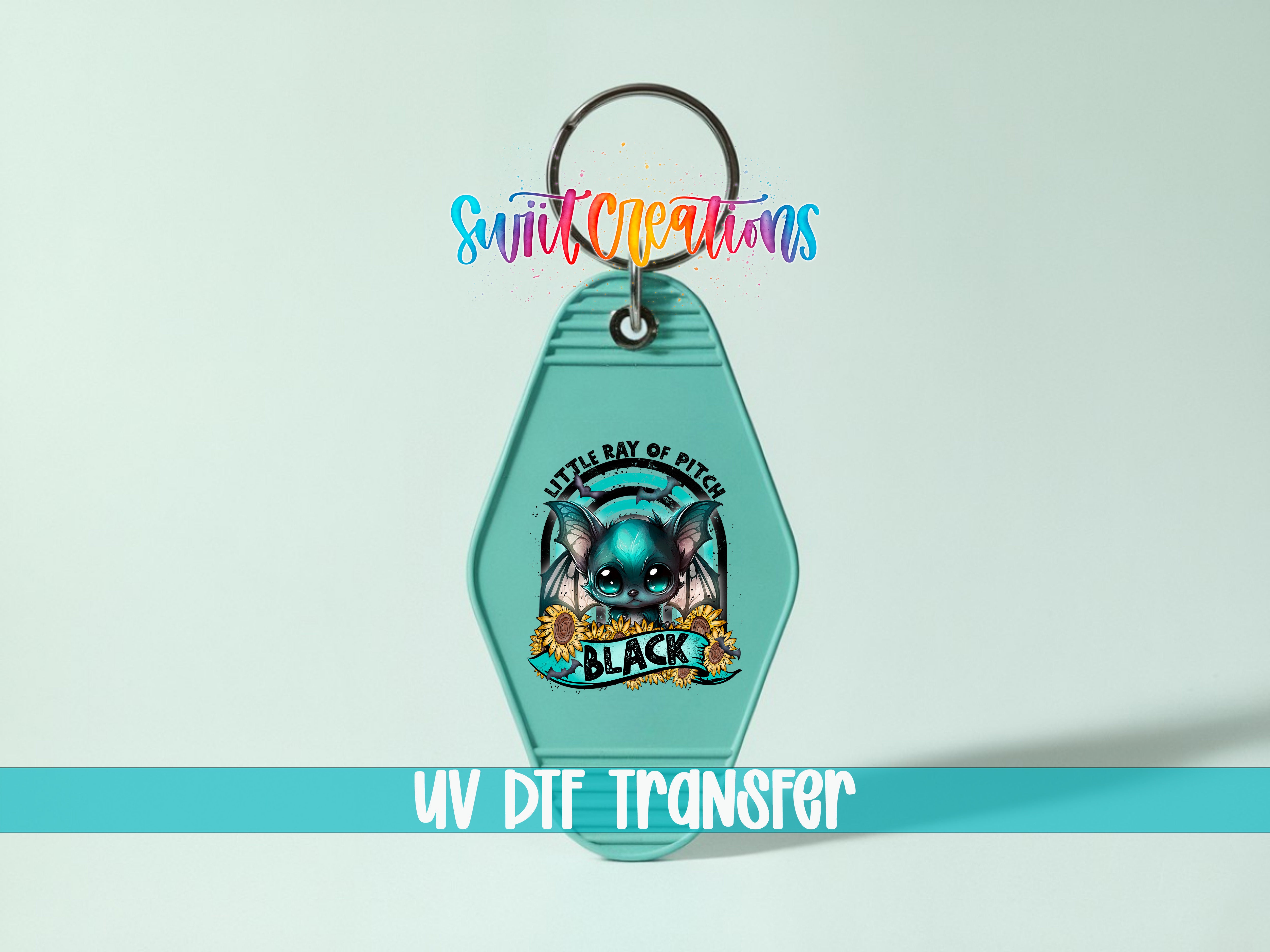 A keychain with a colorful design featuring a cartoon character and the text "Little Ray of Pits" and "Black".