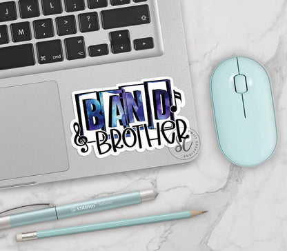 Blue Band Brother vinyl sticker on a silver laptop next to a mint mouse and pens