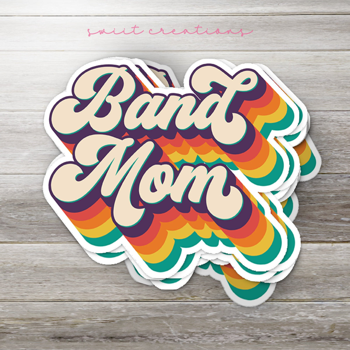 Stack of Retro Band Mom glossy stickers on a gray wood table