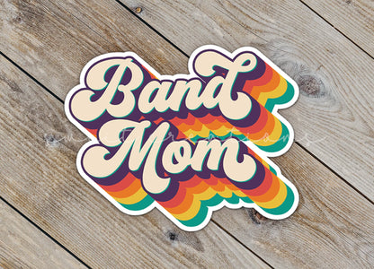 Close-up of the Retro Band Mom sticker on rustic wood