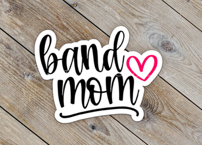 Close-up of the Pink Heart Band Mom sticker on rustic wood