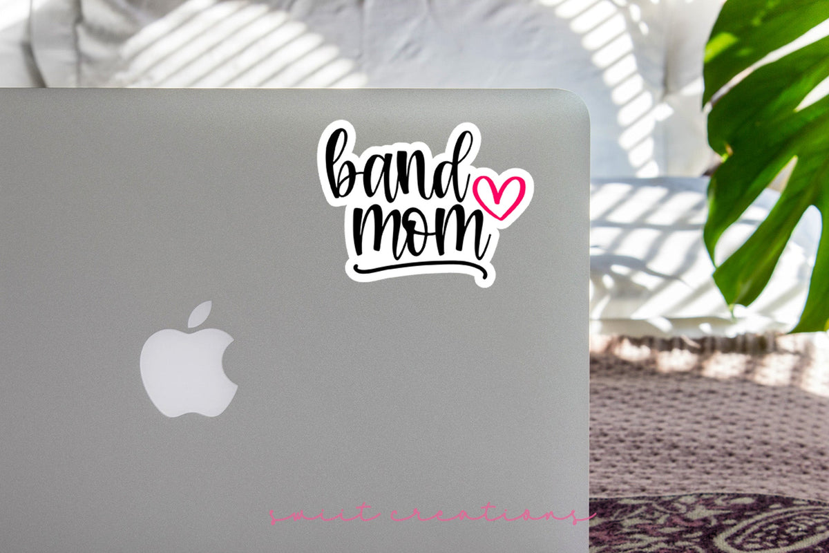 Pink Heart Band Mom sticker on the lid of a silver laptop